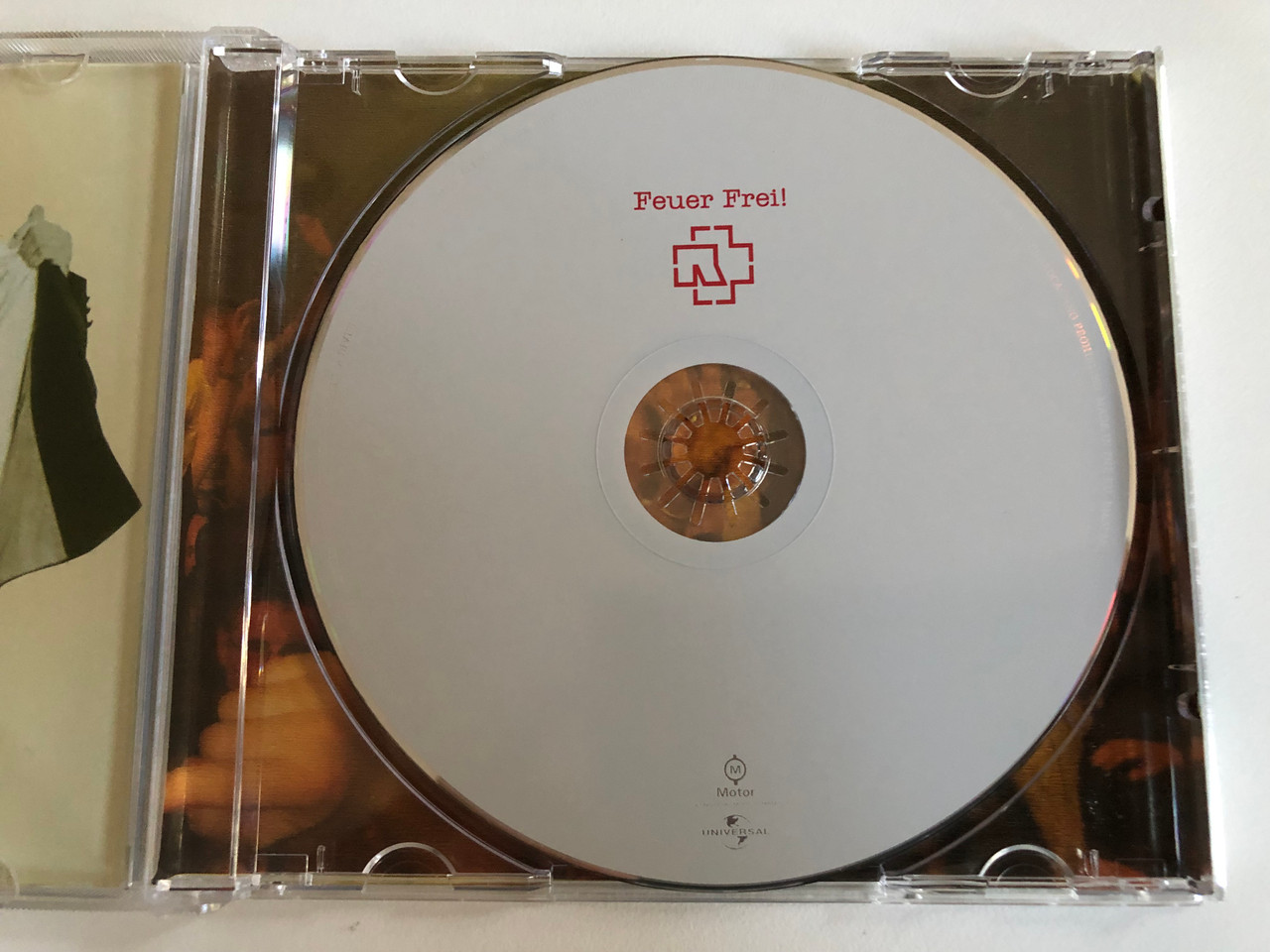https://cdn10.bigcommerce.com/s-62bdpkt7pb/products/0/images/193396/Rammstein_Feuer_Frei_Motor_Music_Audio_CD_2003_570975-2_3__28589.1632933982.1280.1280.JPG?c=2&_gl=1*1ih9du8*_ga*MjA2NTIxMjE2MC4xNTkwNTEyNTMy*_ga_WS2VZYPC6G*MTYzMjkyODkwMC4xMDQuMS4xNjMyOTMzODg2LjYw