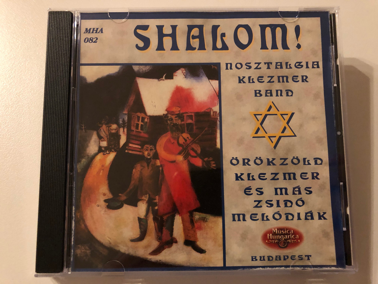 https://cdn10.bigcommerce.com/s-62bdpkt7pb/products/0/images/195179/Shalom_-Nosztalgia_Klezmer_Band_Orokzold_Klezmer_Es_Mas_Zsido_Melodiak_Music_Hungarica_Audio_CD_2000_MHA_082_1__26513.1634021282.1280.1280.JPG?c=2&_gl=1*dvm3o7*_ga*MjA2NTIxMjE2MC4xNTkwNTEyNTMy*_ga_WS2VZYPC6G*MTYzNDAxNTU4Mi4xMjMuMS4xNjM0MDIxMDk3LjU4