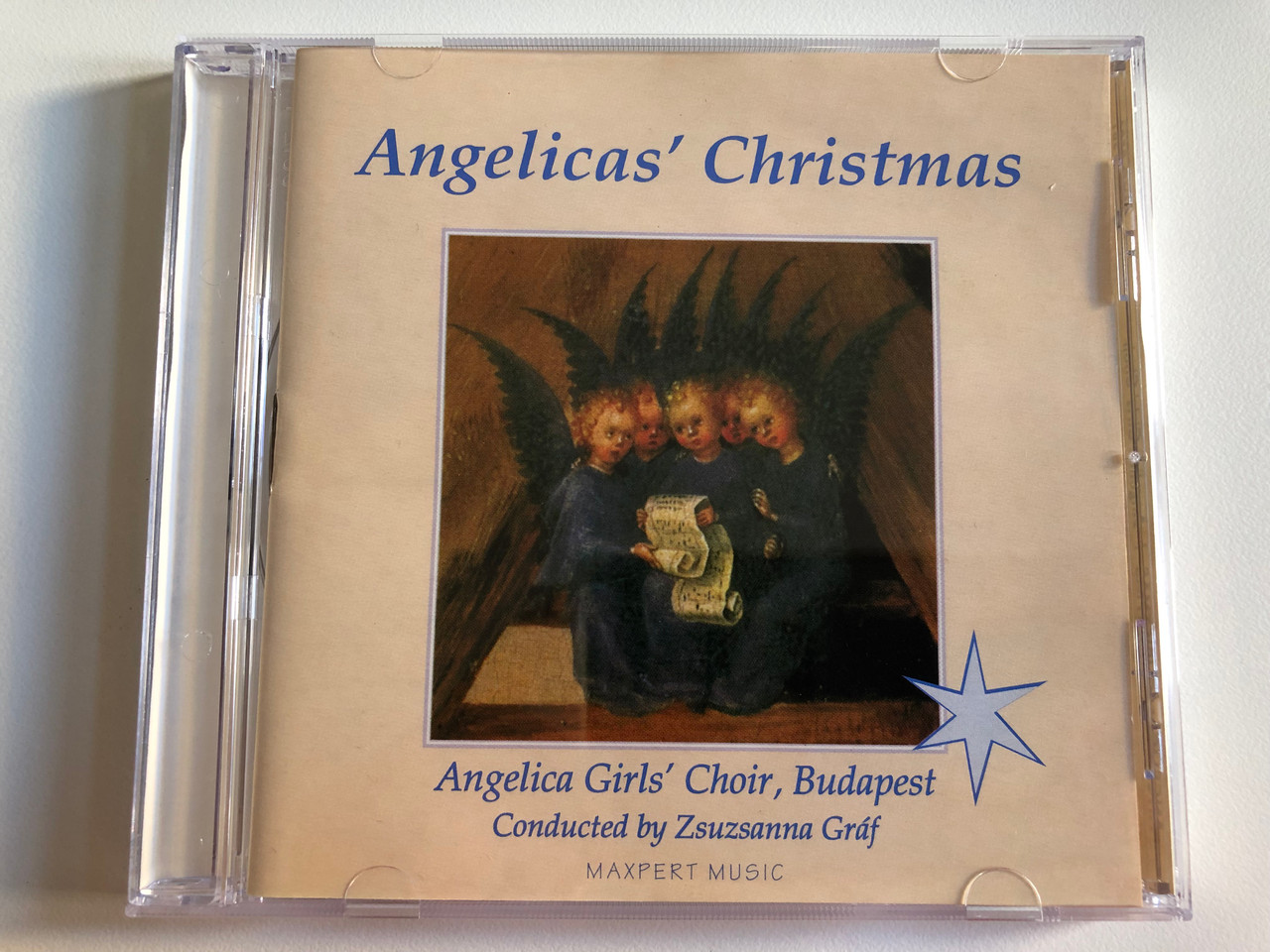 https://cdn10.bigcommerce.com/s-62bdpkt7pb/products/0/images/195742/Angelicas_Christmas_-_Angelica_Girls_Choir_Budapest_Conducted_by_Zsuzsanna_Graf_Maxpert_Music_Audio_CD_1995_MXD-9501_1__73489.1634194544.1280.1280.JPG?c=2&_gl=1*p3wawy*_ga*MjA2NTIxMjE2MC4xNTkwNTEyNTMy*_ga_WS2VZYPC6G*MTYzNDE4MzI0OC4xMjYuMS4xNjM0MTk0MzYwLjQ5