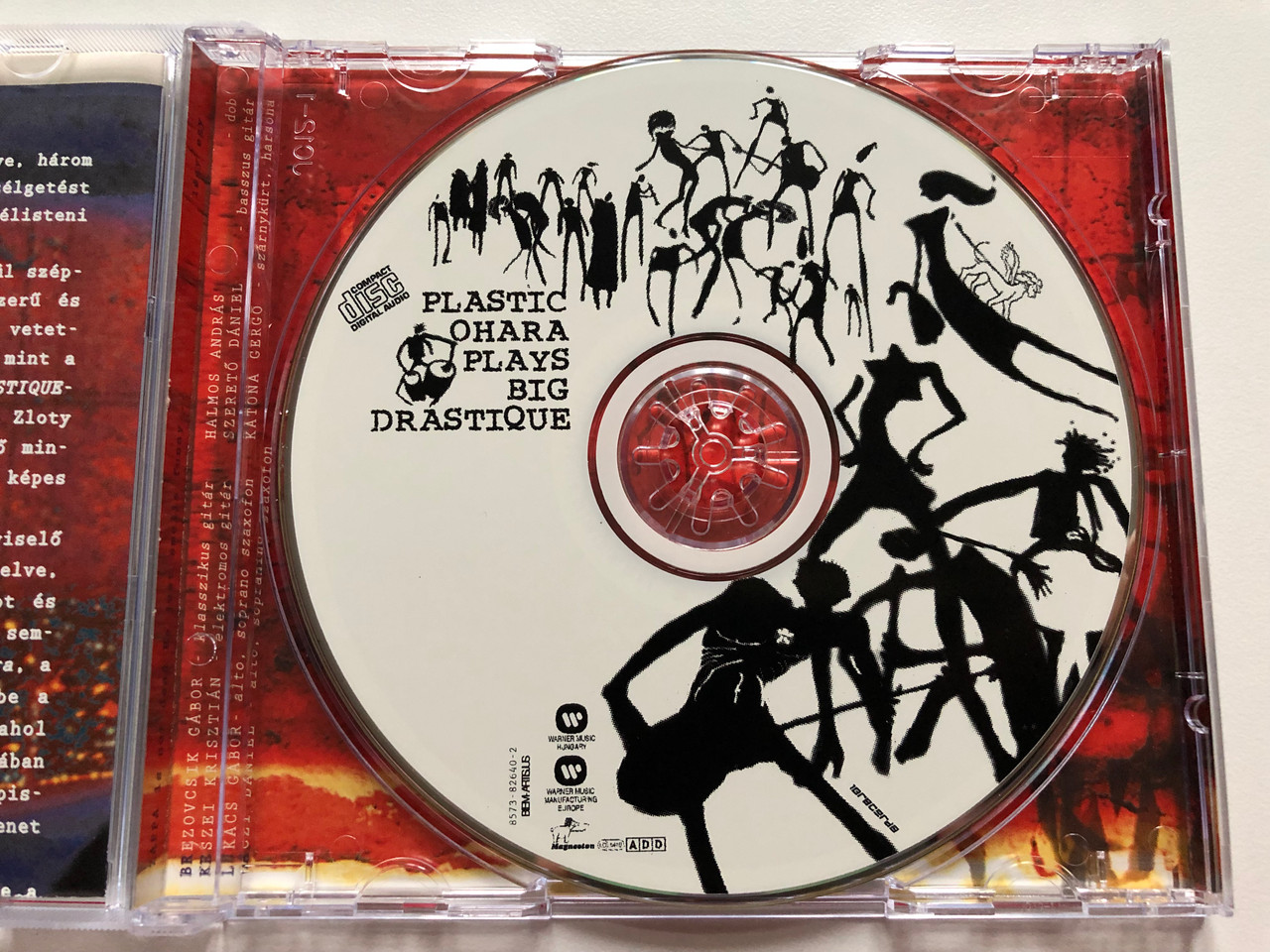 https://cdn10.bigcommerce.com/s-62bdpkt7pb/products/0/images/196162/Plastic_Ohara_Plays_Big_Drastique_Warner_Music_Hungary_Audio_CD_2000_8573-82640-2_3__01370.1634576263.1280.1280.JPG?c=2&_gl=1*q0gka1*_ga*MjA2NTIxMjE2MC4xNTkwNTEyNTMy*_ga_WS2VZYPC6G*MTYzNDU3MzEwMy4xMzEuMS4xNjM0NTc2MTM4LjYw