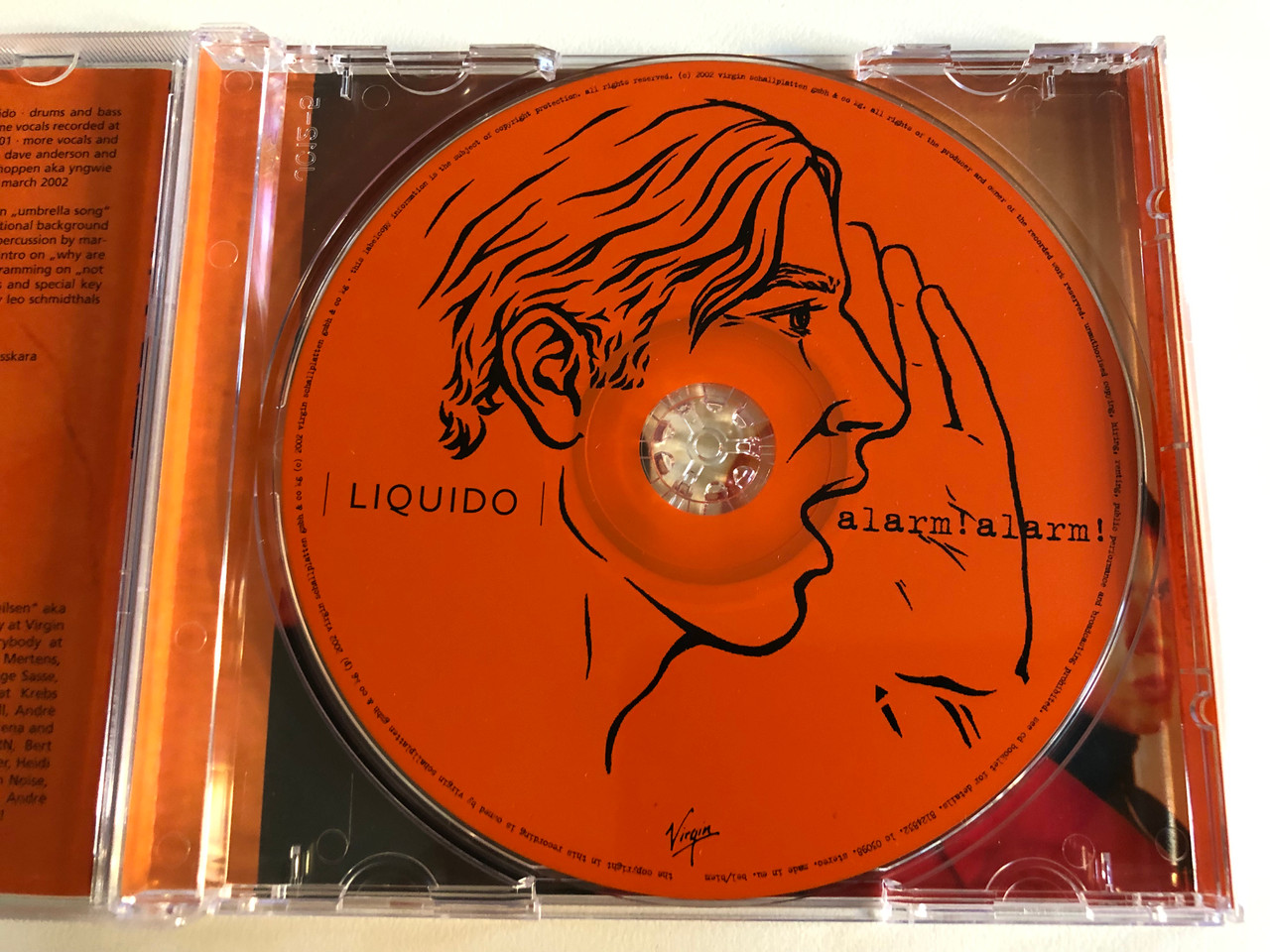 https://cdn10.bigcommerce.com/s-62bdpkt7pb/products/0/images/197211/Liquido_Alarm_Alarm_Virgin_Audio_CD_2002_7243_8124832_4_3__87364.1635323118.1280.1280.JPG?c=2&_gl=1*1ryzyc8*_ga*MjA2NTIxMjE2MC4xNTkwNTEyNTMy*_ga_WS2VZYPC6G*MTYzNTMxNzIzNC4xNDMuMS4xNjM1MzIyODM0LjM.