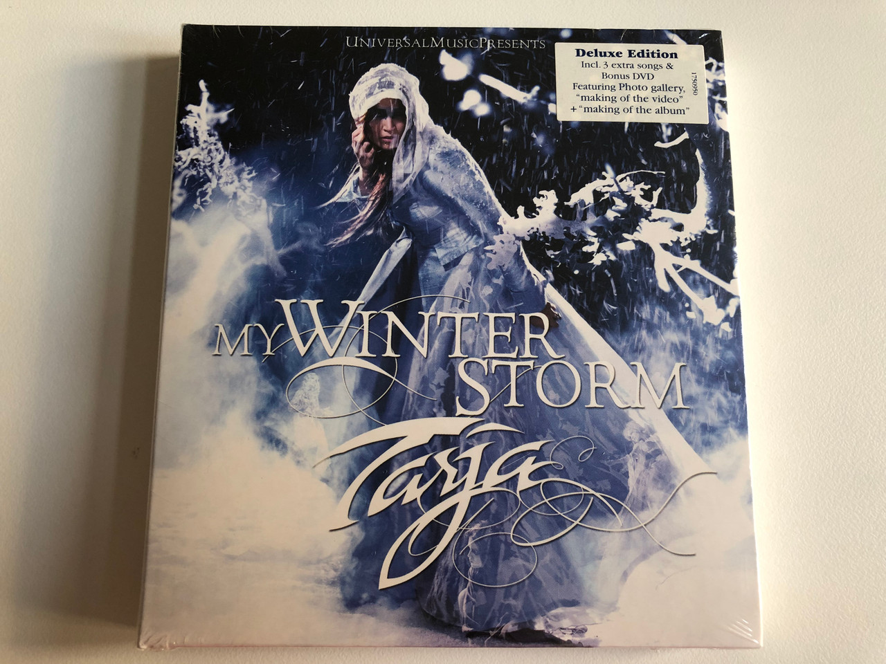 https://cdn10.bigcommerce.com/s-62bdpkt7pb/products/0/images/197823/My_Winter_Storm_-_Tarja_Deluxe_Edition_Incl._3_extra_songs_Bonus_DVD_Featuring_Photo_galerry_making_of_the_video_making_of_the_album_Vertigo_Audio_CD_DVD_2007_006025175_095-0_1__92321.1635793254.1280.1280.JPG?c=2&_gl=1*1uunjwo*_ga*MjA2NTIxMjE2MC4xNTkwNTEyNTMy*_ga_WS2VZYPC6G*MTYzNTc4NDc2OC4xNTAuMS4xNjM1NzkzMDQzLjM2