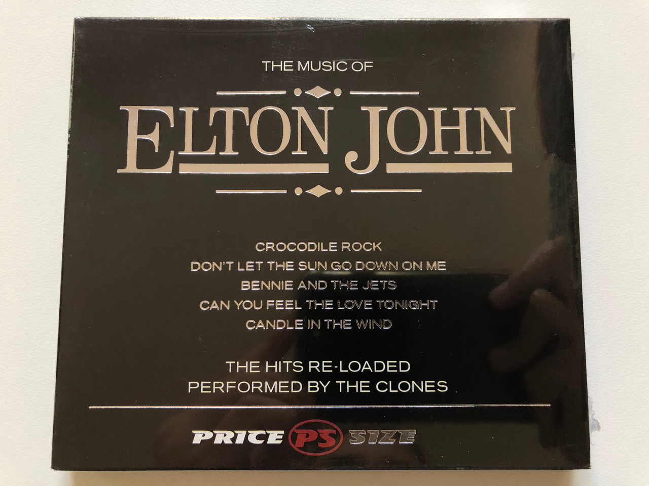https://cdn10.bigcommerce.com/s-62bdpkt7pb/products/0/images/198040/The_Music_Of_Elton_John_Crocodile_Rock_Dont_Let_The_Sun_Go_Down_On_Me_Bennie_And_The_Jets_Can_You_Feel_The_Love_Tonight_Candle_In_The_Wind_The_Hits_Re-Loaded_Performed_by_The_Clones_1__59502.1635926725.1280.1280.JPG?c=2&_gl=1*rmbe7e*_ga*MjA2NTIxMjE2MC4xNTkwNTEyNTMy*_ga_WS2VZYPC6G*MTYzNTkyMjI4Mi4xNTMuMS4xNjM1OTI3MDAwLjYw