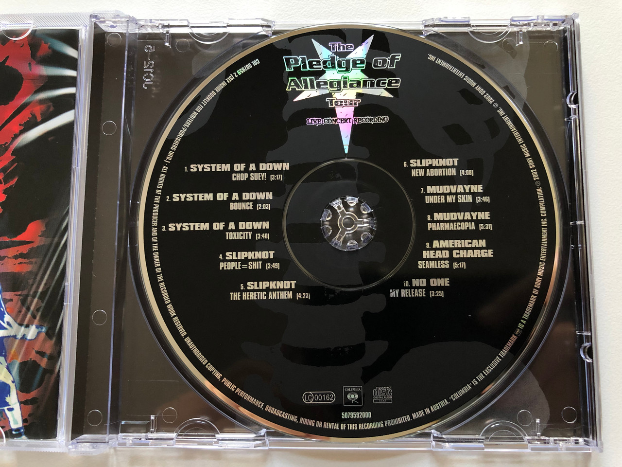 https://cdn10.bigcommerce.com/s-62bdpkt7pb/products/0/images/198171/The_Pledge_Of_Allegiance_Tour_-_Live_Concert_Recording_System_Of_A_Down_Slipknot_Mudvayne_No_One_American_Head_Charge_Columbia_Audio_CD_2002_507959_2_3__33620.1636003612.1280.1280.JPG?c=2&_gl=1*1t4tr8l*_ga*MjA2NTIxMjE2MC4xNTkwNTEyNTMy*_ga_WS2VZYPC6G*MTYzNjAwMjc3Ny4xNTUuMS4xNjM2MDAzNDE3LjQ.