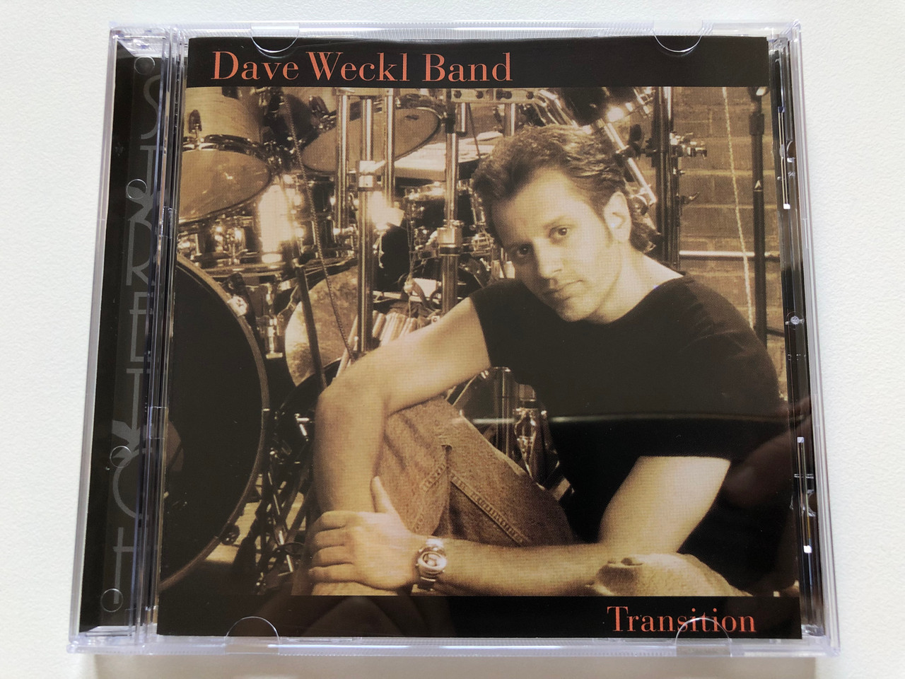 https://cdn10.bigcommerce.com/s-62bdpkt7pb/products/0/images/198185/Dave_Weckl_Band_Transition_Stretch_Records_Audio_CD_2000_SCD-9032-2_1__22285.1636004941.1280.1280.JPG?c=2&_gl=1*g1ev21*_ga*MjA2NTIxMjE2MC4xNTkwNTEyNTMy*_ga_WS2VZYPC6G*MTYzNjAwMjc3Ny4xNTUuMS4xNjM2MDA0ODI5LjE1