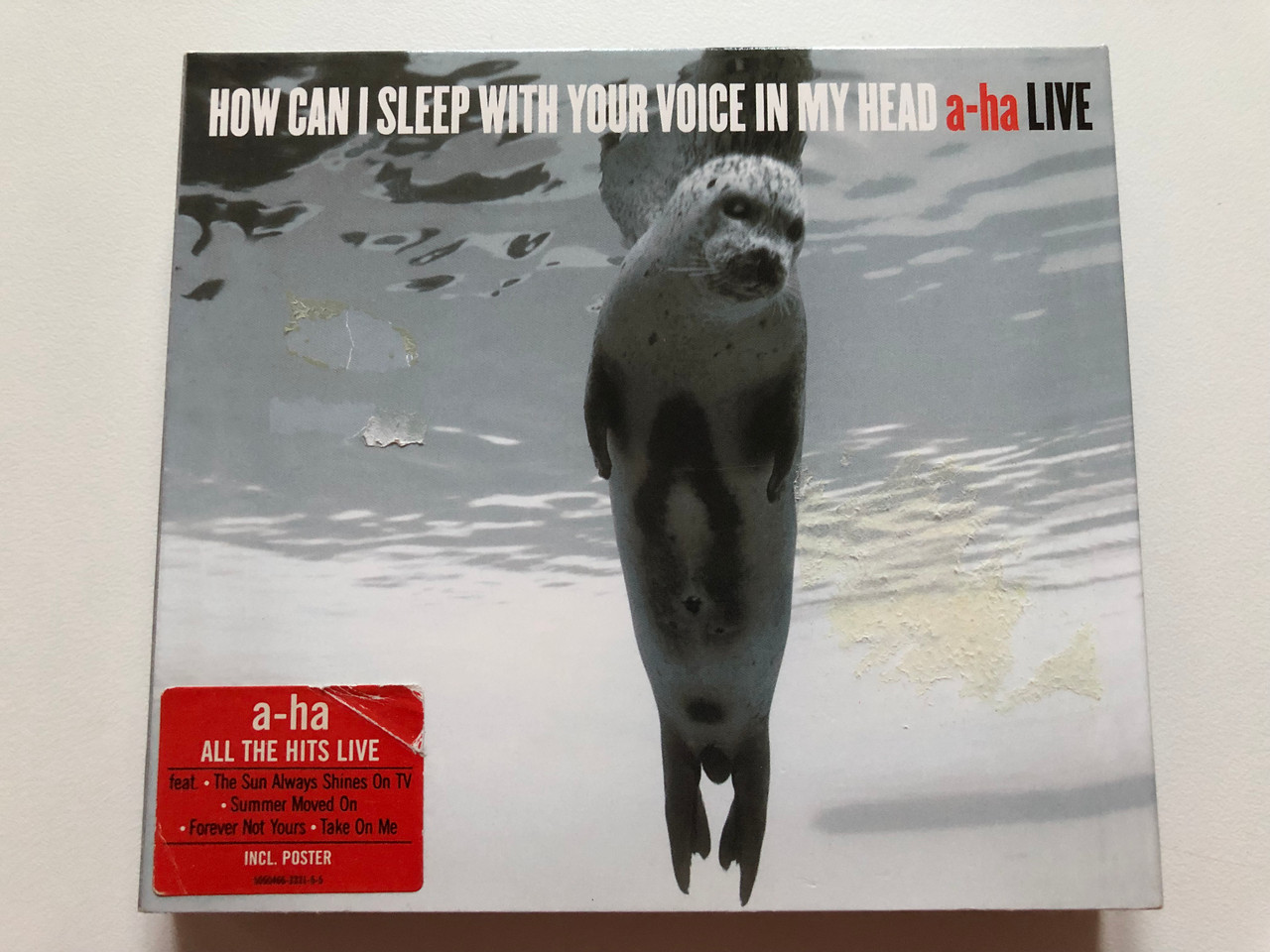 https://cdn10.bigcommerce.com/s-62bdpkt7pb/products/0/images/198800/How_Can_I_Sleep_With_Your_Voice_In_My_Head_-_a-ha_-_LIVE_Feat._The_Sun_Always_Shines_On_TV_Summer_Moved_On_Forever_Not_Yours_Take_On_Me_Incl._Poster_WEA_Records_2x_Audio_CD_2003_5050466_1__06242.1636442162.1280.1280.JPG?c=2&_gl=1*tsyls6*_ga*MjA2NTIxMjE2MC4xNTkwNTEyNTMy*_ga_WS2VZYPC6G*MTYzNjQ0MDUyNy4xNjEuMS4xNjM2NDQxNzAzLjI3