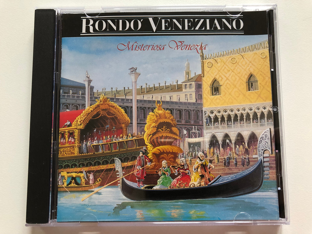 https://cdn10.bigcommerce.com/s-62bdpkt7pb/products/0/images/199140/Rondo_Veneziano_Misteriosa_Venezia_BMG_Audio_CD_1993_Stereo_258_616_1__24593.1636702287.1280.1280.JPG?c=2&_gl=1*1wphwpj*_ga*MjA2NTIxMjE2MC4xNTkwNTEyNTMy*_ga_WS2VZYPC6G*MTYzNjY5OTY5Ni4xNjcuMS4xNjM2NzAyMjQzLjYw