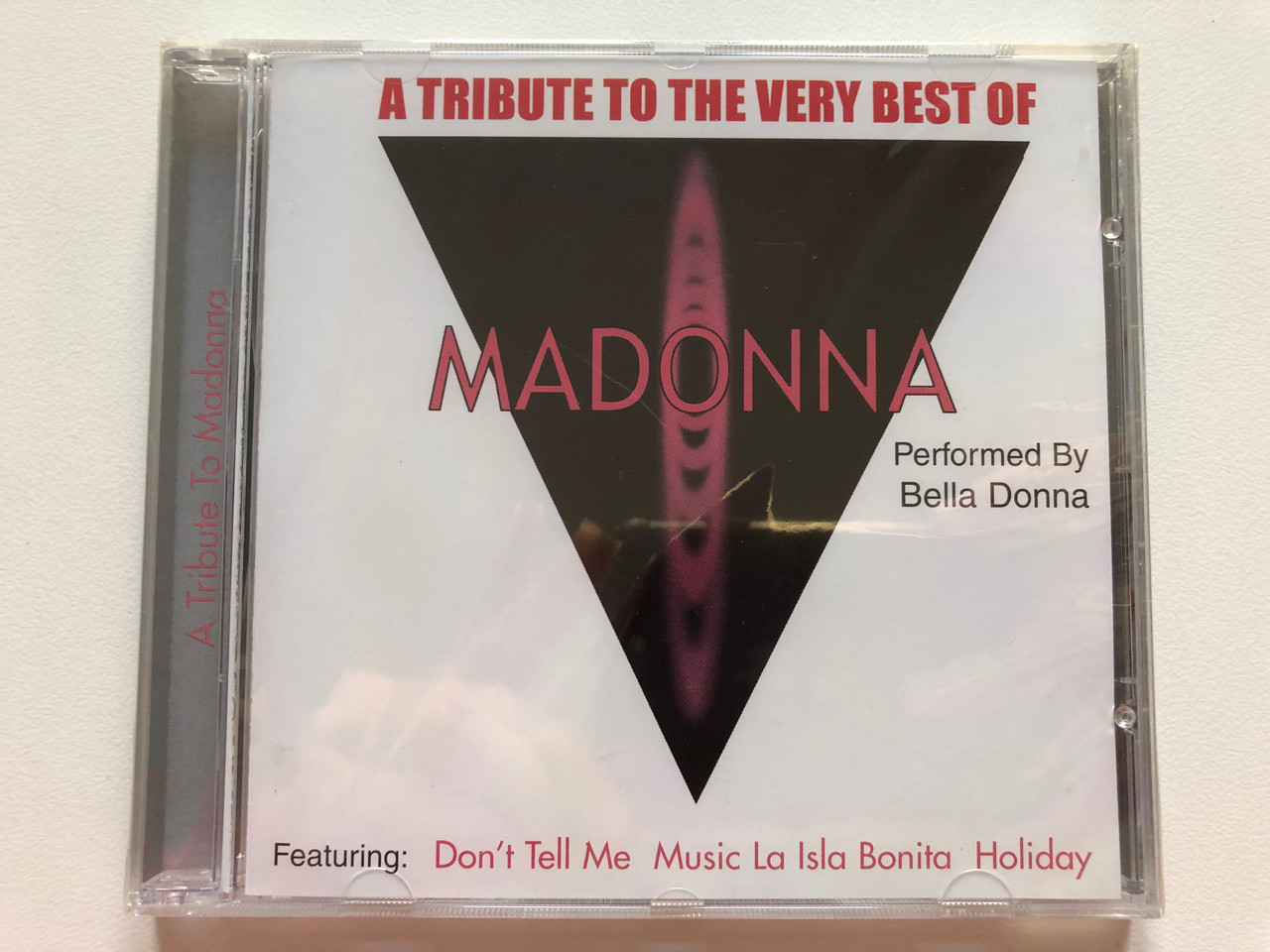 https://cdn10.bigcommerce.com/s-62bdpkt7pb/products/0/images/200101/A_Tribute_To_The_Very_Best_Of_Madonna_-_Performed_by_Bella_Donna_Featuring_Dont_Tell_Me_Music_La_Isla_Bonita_Holiday_Cosmopolitan_Audio_CD_2001_40612-2_1__35210.1637658939.1280.1280.JPG?c=2&_gl=1*oegp79*_ga*MjA2NTIxMjE2MC4xNTkwNTEyNTMy*_ga_WS2VZYPC6G*MTYzNzY1NDY3Ni4xODEuMS4xNjM3NjU4OTM1LjYw