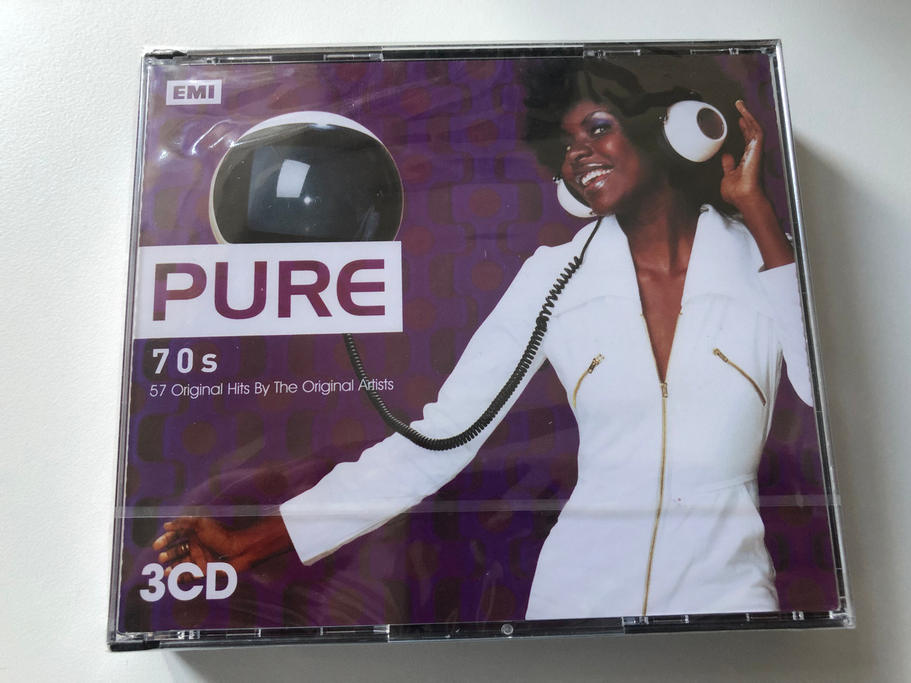https://cdn10.bigcommerce.com/s-62bdpkt7pb/products/0/images/200478/Pure_70s_-_57_Original_Hits_By_The_Original_Artists_EMI_3x_Audio_CD_2007_5099950829620_1__28492.1637859173.1280.1280.JPG?c=2&_gl=1*1it5c64*_ga*MjA2NTIxMjE2MC4xNTkwNTEyNTMy*_ga_WS2VZYPC6G*MTYzNzg1MjczMi4xODkuMS4xNjM3ODU5MTUxLjYw
