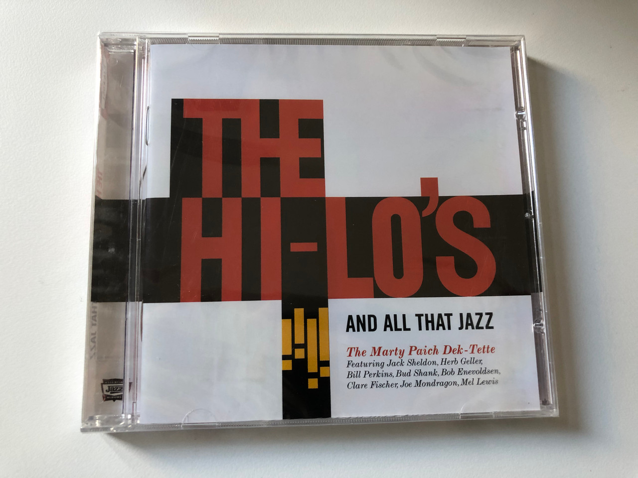 https://cdn10.bigcommerce.com/s-62bdpkt7pb/products/0/images/200509/The_Hi-Los_And_All_That_Jazz_The_Marty_Paich_Dek-Tette_Featuring_Jack_Sheldon_Herb_Geller_Bill_Perkins_Bud_Shank_Bob_Enevoldsen_Clare_Fisher_Joe_Mondragon_Mel_Levis_Essential_Jaz_1__69837.1637912669.1280.1280.JPG?c=2&_gl=1*75kqg0*_ga*MjA2NTIxMjE2MC4xNTkwNTEyNTMy*_ga_WS2VZYPC6G*MTYzNzkwOTc3NC4xOTAuMS4xNjM3OTEyNDUxLjQ5