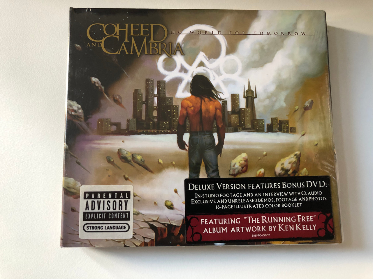 https://cdn10.bigcommerce.com/s-62bdpkt7pb/products/0/images/200660/Coheed_And_Cambria_No_World_For_Tomorrow_Deluxe_Version_Features_Bonus_DVD_In-Studio_Footage_And_An_Interview_With_Claudio_Featuring_The_Running_Free_Album_Artwork_By_Ken_Kelly_Colum_1__46835.1638185425.1280.1280.JPG?c=2&_gl=1*1s8resz*_ga*MjA2NTIxMjE2MC4xNTkwNTEyNTMy*_ga_WS2VZYPC6G*MTYzODE3MTM4NC4xOTMuMS4xNjM4MTg0NjQ0LjE2