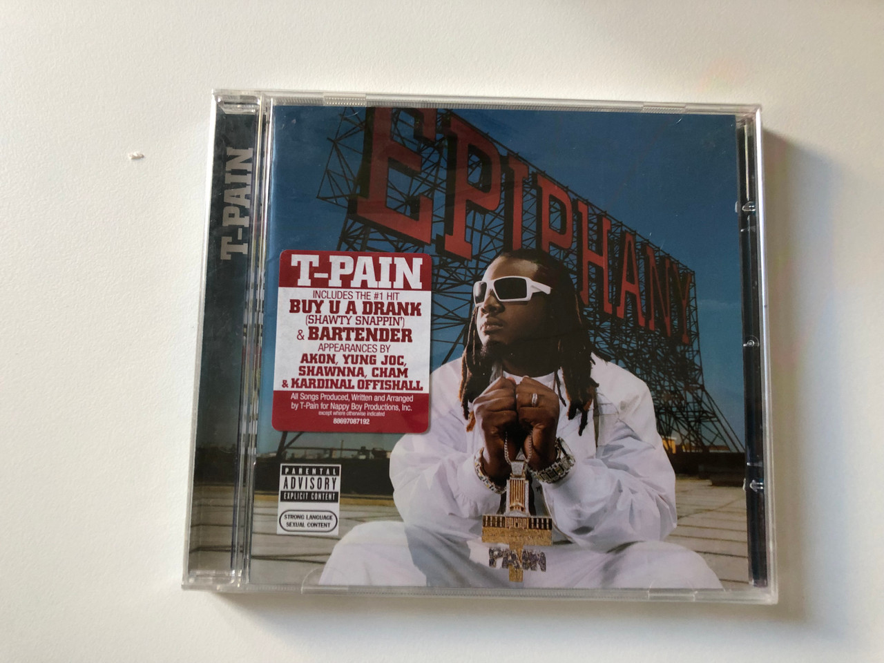 https://cdn10.bigcommerce.com/s-62bdpkt7pb/products/0/images/200729/T-Pain_Epiphany_Includes_The_1_Hit_Buy_U_A_Drank_Shawty_Snappin_Bartender_Appearances_By_Akon_Yung_Joc_Shawnna_Cham_Kardinal_Offishall_Nappy_Boy_Entertainment_Audio_CD_200_1__86106.1638263082.1280.1280.JPG?c=2&_gl=1*1lhm1gg*_ga*MjA2NTIxMjE2MC4xNTkwNTEyNTMy*_ga_WS2VZYPC6G*MTYzODI1NzAzMC4xOTQuMS4xNjM4MjYzMDI2LjYw
