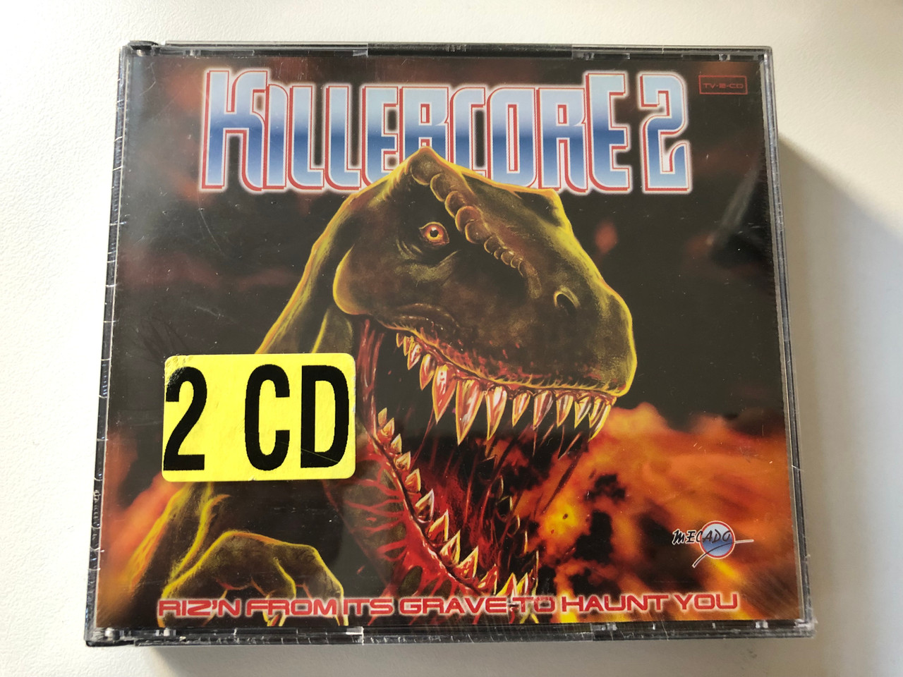 https://cdn10.bigcommerce.com/s-62bdpkt7pb/products/0/images/200957/Killercore_2_Rizn_From_Its_Grave_To_Haunt_You_MECADO_2x_Audio_CD_1997_MEC_10179_1__33236.1638445594.1280.1280.JPG?c=2&_gl=1*1rxa7bw*_ga*MjA2NTIxMjE2MC4xNTkwNTEyNTMy*_ga_WS2VZYPC6G*MTYzODQ0MDM5Mi4xOTkuMS4xNjM4NDQ1MTc5LjIy