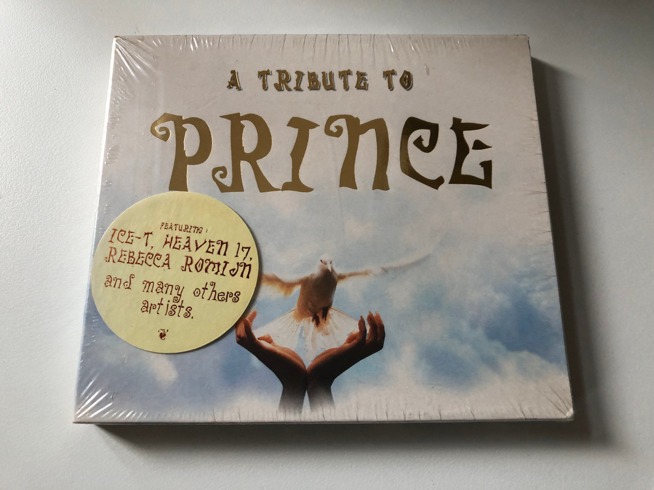 https://cdn10.bigcommerce.com/s-62bdpkt7pb/products/0/images/201135/A_Tribute_To_Prince_Featuring_Ice-T_Heaven_17_Rebecca_Romijn_and_manz_others_artists_Remedy_Audio_CD_2000_3055672_1__34788.1638819935.1280.1280.JPG?c=2&_gl=1*h9yb9g*_ga*MjA2NTIxMjE2MC4xNTkwNTEyNTMy*_ga_WS2VZYPC6G*MTYzODgxOTE0NS4yMDMuMS4xNjM4ODE5NzQxLjU4