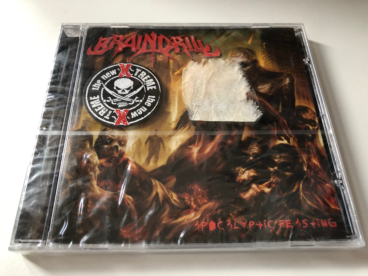 https://cdn10.bigcommerce.com/s-62bdpkt7pb/products/0/images/201139/Brain_Drill_Apocalyptic_Feasting_Metal_Blade_Records_Audio_CD_2008_3984-14657-2_1__50404.1638820336.1280.1280.JPG?c=2&_gl=1*9f7gzf*_ga*MjA2NTIxMjE2MC4xNTkwNTEyNTMy*_ga_WS2VZYPC6G*MTYzODgxOTE0NS4yMDMuMS4xNjM4ODIwMTM2LjI3
