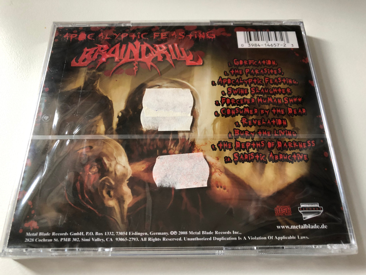 https://cdn10.bigcommerce.com/s-62bdpkt7pb/products/0/images/201140/Brain_Drill_Apocalyptic_Feasting_Metal_Blade_Records_Audio_CD_2008_3984-14657-2_2__05652.1638820336.1280.1280.JPG?c=2&_gl=1*9f7gzf*_ga*MjA2NTIxMjE2MC4xNTkwNTEyNTMy*_ga_WS2VZYPC6G*MTYzODgxOTE0NS4yMDMuMS4xNjM4ODIwMTM2LjI3