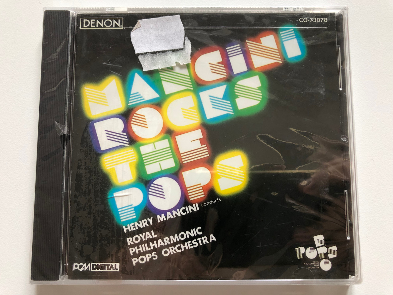 https://cdn10.bigcommerce.com/s-62bdpkt7pb/products/0/images/201219/Mancini_Rocks_The_Pops_-_Henry_Mancini_conducts_Royal_Philharmonic_Pops_Orchestra_Denon_Audio_CD_1989_Stereo_CO-73078_1__03837.1638902152.1280.1280.JPG?c=2&_gl=1*gb4dqm*_ga*MjA2NTIxMjE2MC4xNTkwNTEyNTMy*_ga_WS2VZYPC6G*MTYzODg5MjM0OC4yMDUuMS4xNjM4OTAxOTczLjQ0