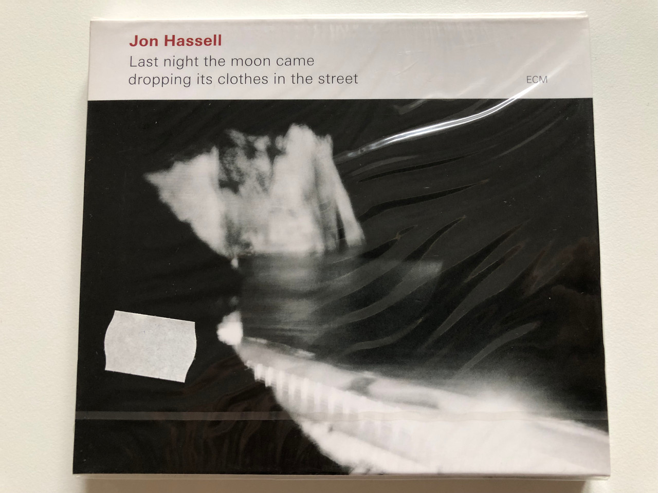 https://cdn10.bigcommerce.com/s-62bdpkt7pb/products/0/images/201246/Jon_Hassell_Last_Night_The_Moon_Came_Dropping_Its_Clothes_In_The_Street_ECM_Records_Audio_CD_2009_ECM_2077_1__52926.1638973273.1280.1280.JPG?c=2&_gl=1*towm4a*_ga*MjA2NTIxMjE2MC4xNTkwNTEyNTMy*_ga_WS2VZYPC6G*MTYzODk3MDI5OS4yMDYuMS4xNjM4OTczMTc0LjU4