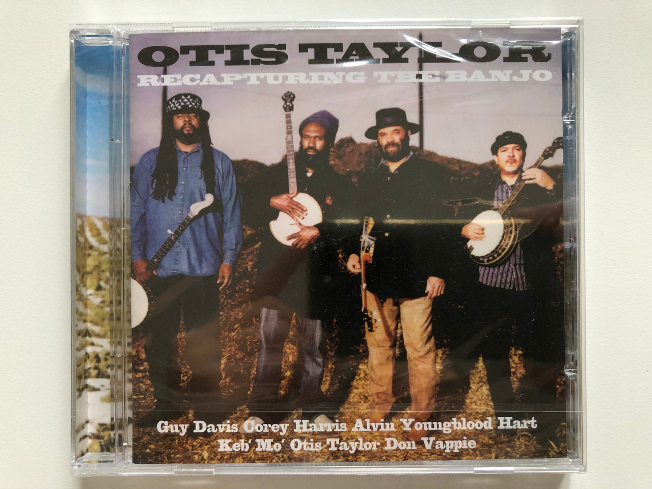 https://cdn10.bigcommerce.com/s-62bdpkt7pb/products/0/images/201281/Otis_Taylor_-_Recapturing_The_Banjo_-_Guy_Davis_Corey_Harris_Alvin_Youngblood_Hart_Keb_Mo_Otis_Taylor_Don_Vappie_Telarc_Audio_CD_2008_CD-83667_1__45936.1638979346.1280.1280.JPG?c=2&_gl=1*3ygiii*_ga*MjA2NTIxMjE2MC4xNTkwNTEyNTMy*_ga_WS2VZYPC6G*MTYzODk3MDI5OS4yMDYuMS4xNjM4OTc5MTI2LjQy