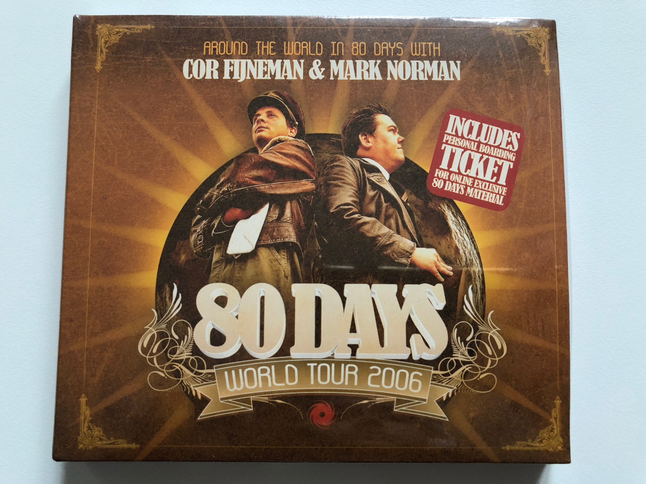 https://cdn10.bigcommerce.com/s-62bdpkt7pb/products/0/images/201623/Around_The_World_In_80_Days_With_Cor_Fijneman_Mark_Norman_-_80_Days_World_Tour_20063_Includes_Personal_Boarding_Ticket_For_Online_Exclusive_80_Days_Material_Black_Hole_Recordings_2x_Audio_1__51827.1639393405.1280.1280.JPG?c=2&_gl=1*93oxcl*_ga*MjA2NTIxMjE2MC4xNTkwNTEyNTMy*_ga_WS2VZYPC6G*MTYzOTM5MDc3NS4yMTIuMS4xNjM5MzkzMDkyLjM1