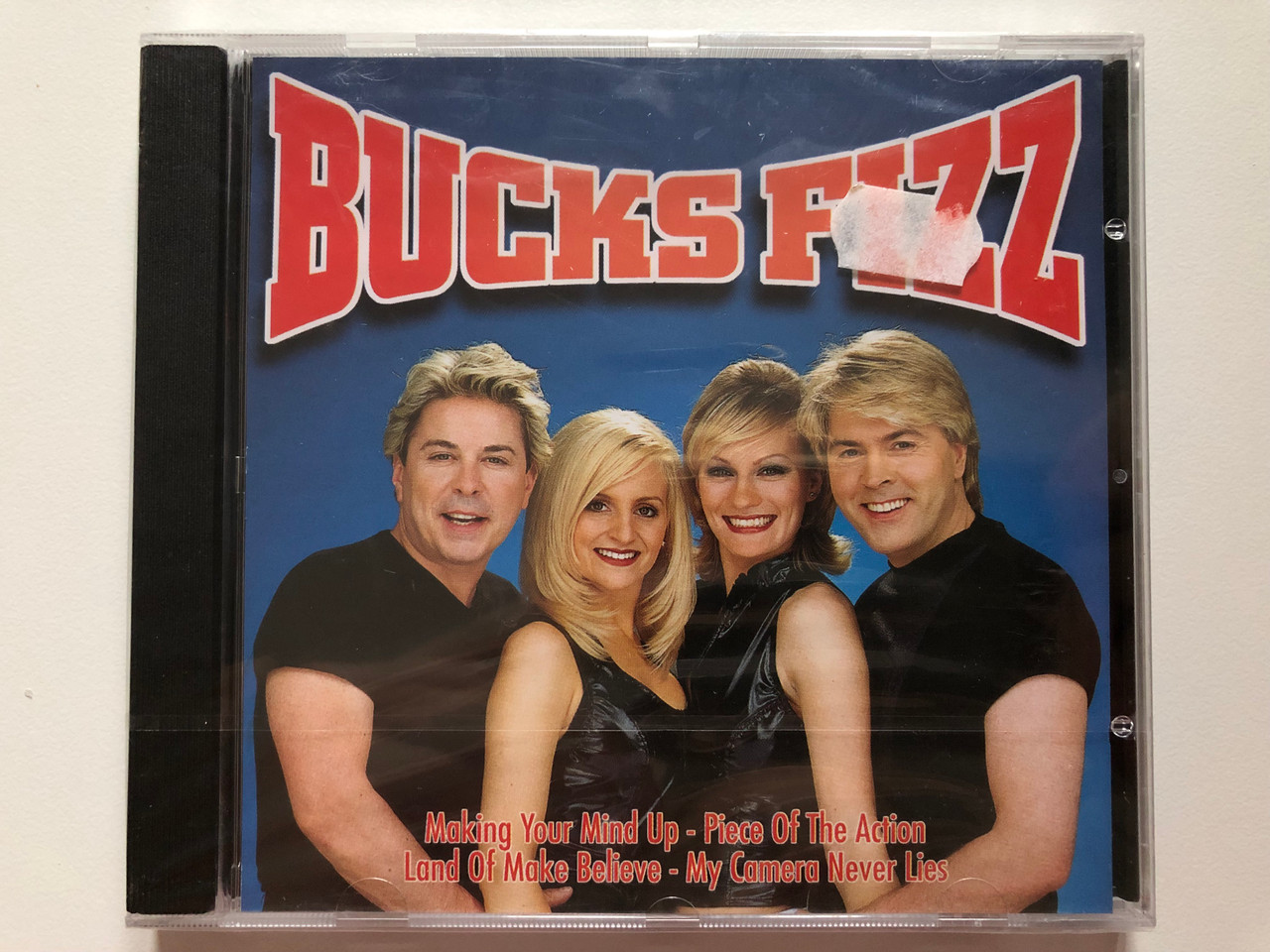 https://cdn10.bigcommerce.com/s-62bdpkt7pb/products/0/images/202310/Bucks_Fizz_-_Making_Your_Mind_Up_Piece_Of_The_Action_Land_Of_Make_Believe_My_Camera_Never_Lies_Forever_Gold_Audio_CD_2001_FG012_1__12540.1640003727.1280.1280.JPG?c=2&_gl=1*syngmj*_ga*MjA2NTIxMjE2MC4xNTkwNTEyNTMy*_ga_WS2VZYPC6G*MTY0MDAwMjY5NC4yMjQuMS4xNjQwMDAzNTkxLjU2