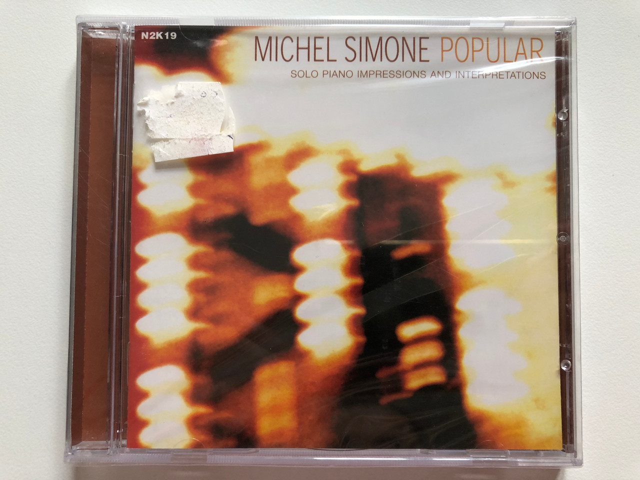https://cdn10.bigcommerce.com/s-62bdpkt7pb/products/0/images/202558/Michel_Simone_-_Popular_-_Solo_Piano_Impressions_And_Interpretations_n2k_Audio_CD_2000_N2K19_1__70074.1640157109.1280.1280.JPG?c=2&_gl=1*1hz0r5x*_ga*MjA2NTIxMjE2MC4xNTkwNTEyNTMy*_ga_WS2VZYPC6G*MTY0MDE1NDY1OS4yMjYuMS4xNjQwMTU2OTIyLjU3