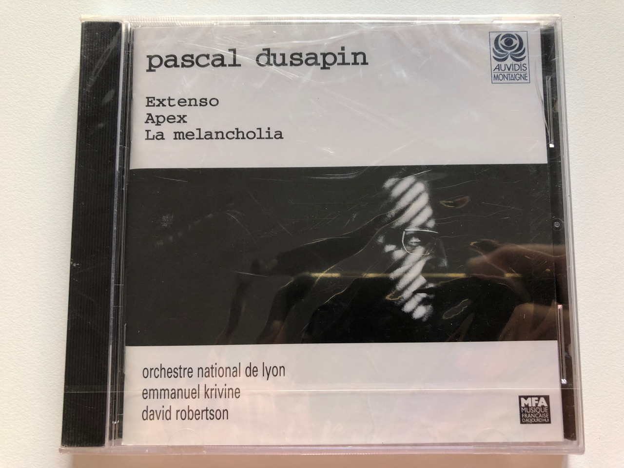 https://cdn10.bigcommerce.com/s-62bdpkt7pb/products/0/images/202991/Pascal_Dusapin_-_Extenso_Apex_La_Melancholia_Orchestre_National_De_Lyon_Emmanuel_Krivine_David_Robertson_Montaigne_Audio_CD_1997_MO_782073_1__20842.1640369913.1280.1280.JPG?c=2&_gl=1*17xo1o5*_ga*MjA2NTIxMjE2MC4xNTkwNTEyNTMy*_ga_WS2VZYPC6G*MTY0MDM2MjE0NS4yMzUuMS4xNjQwMzY5ODIxLjM1