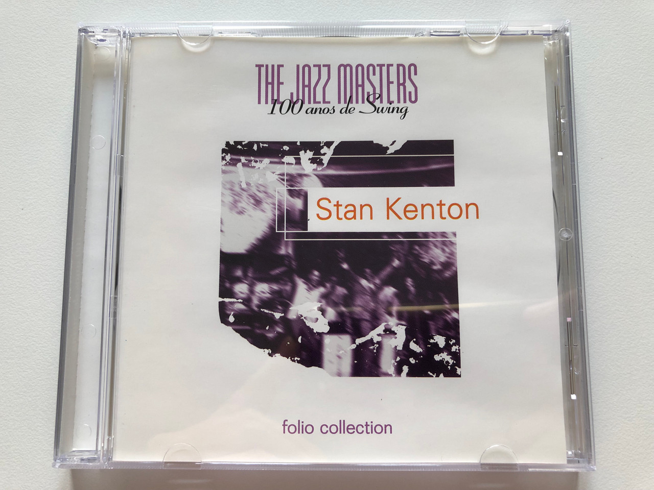 https://cdn10.bigcommerce.com/s-62bdpkt7pb/products/0/images/203495/Stan_Kenton_The_Jazz_Masters_-_100_Aos_Of_Swing_Folio_Collection_Audio_CD_1996_EF_20024_1__15078.1640799494.1280.1280.JPG?c=2&_gl=1*lxmlc7*_ga*MjA2NTIxMjE2MC4xNTkwNTEyNTMy*_ga_WS2VZYPC6G*MTY0MDc4NDQ2Mi4yMzguMS4xNjQwNzk5MzYzLjYw