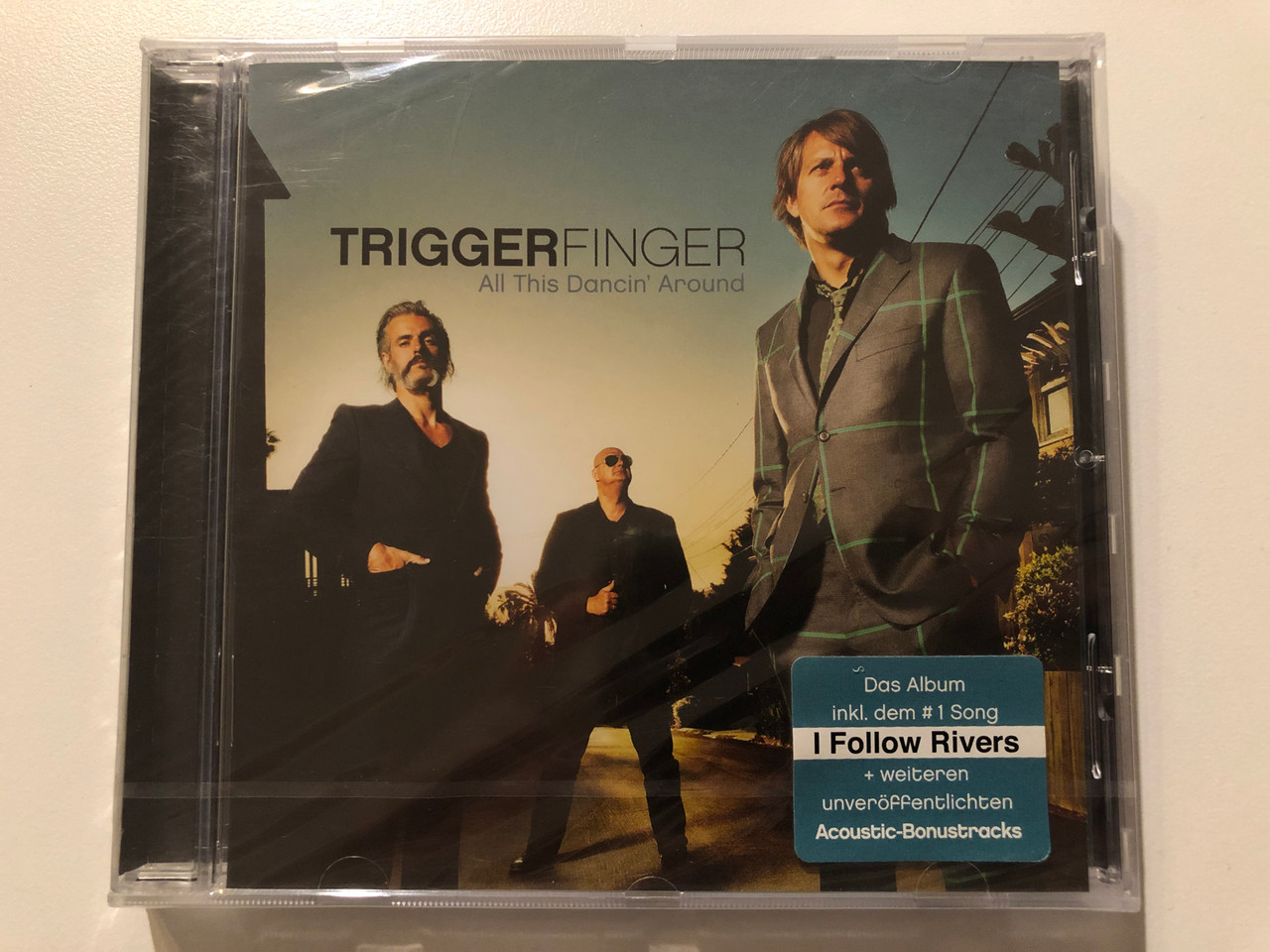 https://cdn10.bigcommerce.com/s-62bdpkt7pb/products/0/images/204035/Triggerfinger_All_This_Dancin_Around_Das_Album_inkl._dem_1_song_I_Follow_Rivers_weiteren_unveroffentlichten_Acoustic-Bonustracks_Universal_Music_Audio_CD_2012_0602537075768_1__39258.1641196738.1280.1280.JPG?c=2&_gl=1*1b9prvd*_ga*MjA2NTIxMjE2MC4xNTkwNTEyNTMy*_ga_WS2VZYPC6G*MTY0MTE5NDMxMi4yNDQuMS4xNjQxMTk2NDcwLjQ.