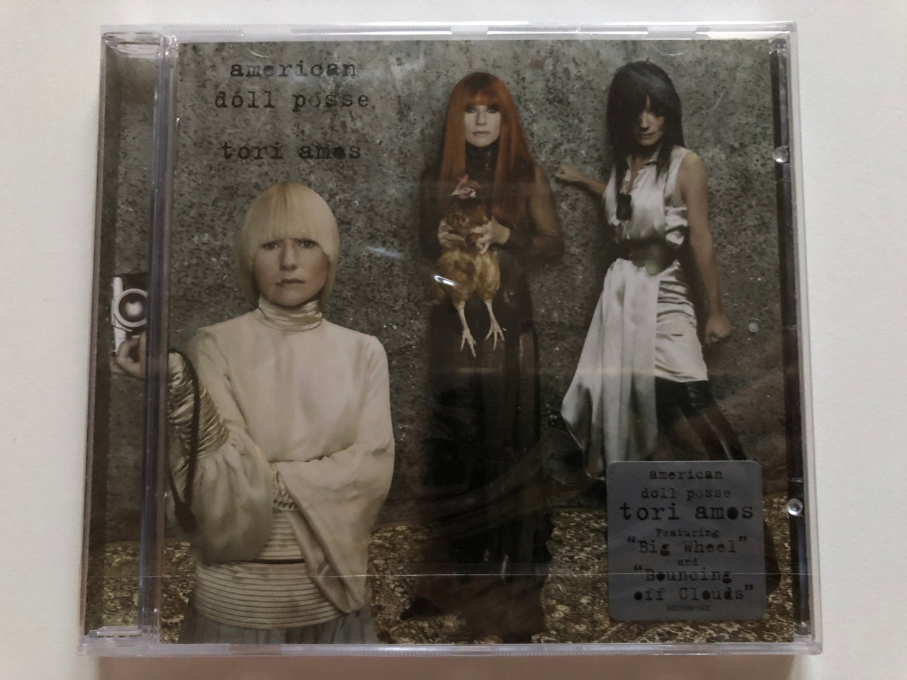 https://cdn10.bigcommerce.com/s-62bdpkt7pb/products/0/images/204521/Tori_Amos_American_Doll_Posse_Featuring_Big_Wheel_and_Bouncing_Off_Clouds_Epic_Audio_CD_2007_82876861402_1__97806.1641368453.1280.1280.JPG?c=2&_gl=1*jpsqq8*_ga*MjA2NTIxMjE2MC4xNTkwNTEyNTMy*_ga_WS2VZYPC6G*MTY0MTM1OTgzNy4yNDcuMS4xNjQxMzY3ODY5LjM4