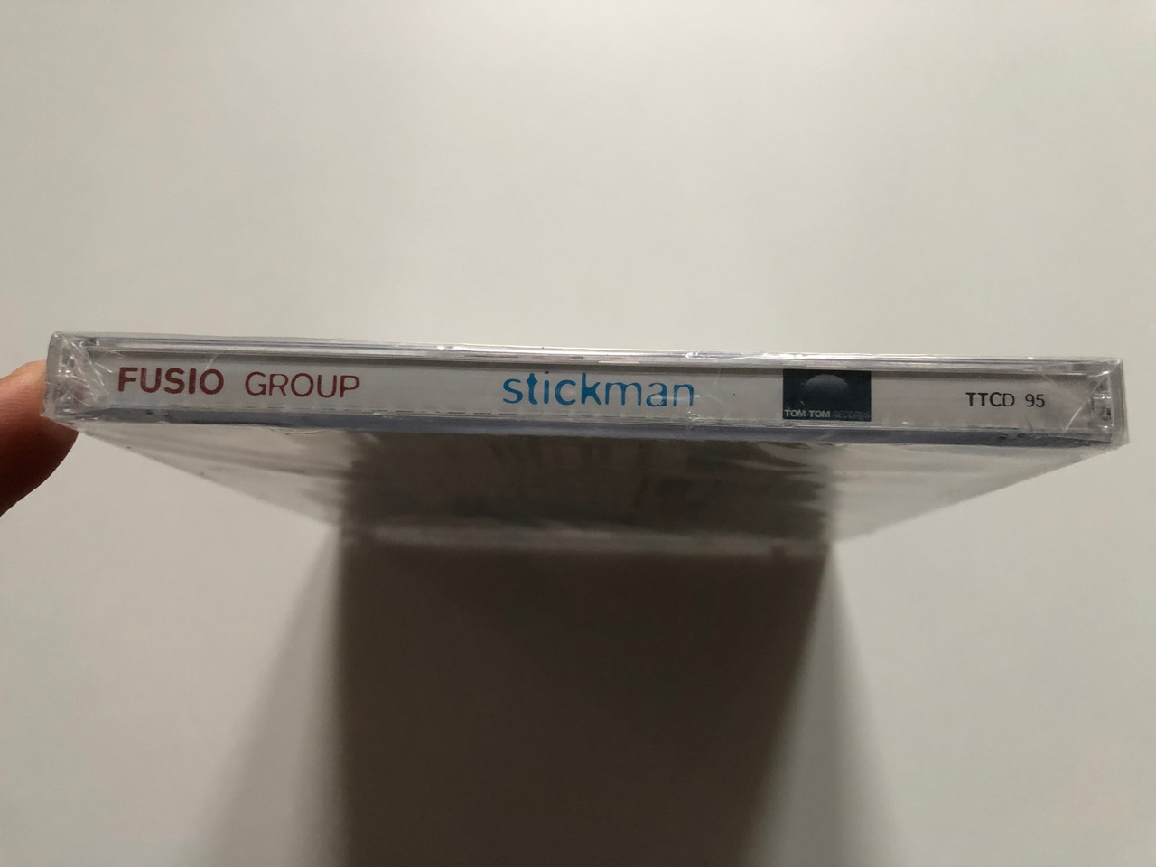 https://cdn10.bigcommerce.com/s-62bdpkt7pb/products/0/images/204940/Fusio_Group_Stickman_Tom-Tom_Records_Audio_CD_2007_TTCD_95_3__59403.1641541309.1280.1280.JPG?c=2&_gl=1*14rpub6*_ga*MjA2NTIxMjE2MC4xNTkwNTEyNTMy*_ga_WS2VZYPC6G*MTY0MTUzNDM0OS4yNTEuMS4xNjQxNTQxMjE1LjMy