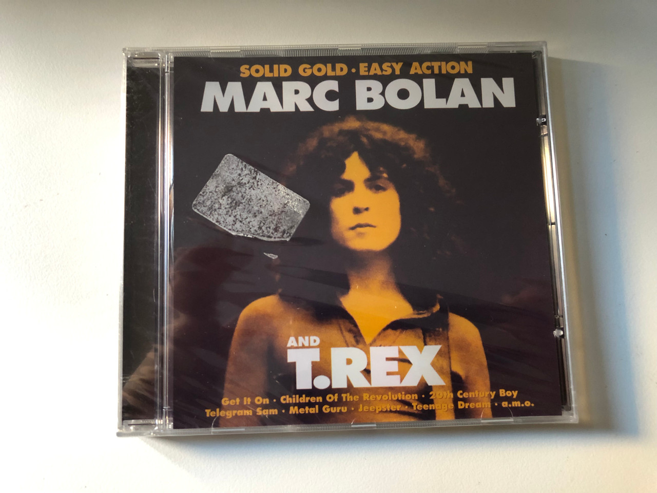 https://cdn10.bigcommerce.com/s-62bdpkt7pb/products/0/images/206519/Marc_Bolan_And_T.Rex_Solid_Gold_Easy_Action_Get_It_On_Children_Of_The_Revolution_20th_Century_Boy_Telegram_Sam_Metal_Guru_Jeepster_Teenage_Dream_a._m._o._Eurotrend_Audio_CD_2003_1__19480.1642084233.1280.1280.JPG?c=2&_gl=1*5ygwj2*_ga*MjA2NTIxMjE2MC4xNTkwNTEyNTMy*_ga_WS2VZYPC6G*MTY0MjA4NDAyMS4yNjEuMS4xNjQyMDg0MDY0LjE3