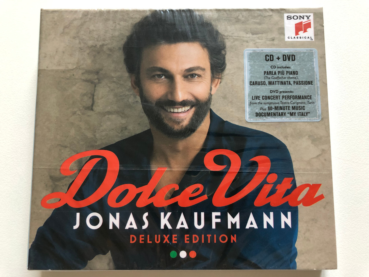 https://cdn10.bigcommerce.com/s-62bdpkt7pb/products/0/images/208174/Dolce_Vita_-_Jonas_Kaufmann_-_Deluxe_Edition_CD_DVD_CD_includes_Parla_Piu_Piano_The_Godfather_theme_Caruso_Mattinata_Passione_DVD_presents_Live_Concert_Sony_Classical_Audio_CD_DV_1__03245.1642677273.1280.1280.JPG?c=2&_gl=1*1t06qj1*_ga*MjA2NTIxMjE2MC4xNTkwNTEyNTMy*_ga_WS2VZYPC6G*MTY0MjY3NjgyNy4yNjguMS4xNjQyNjc3MjUxLjYw