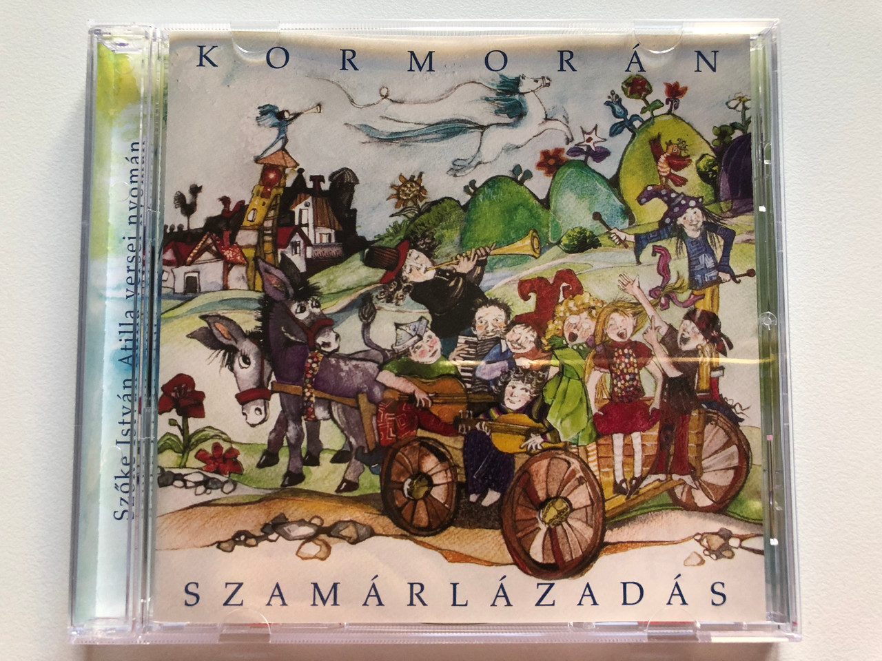 https://cdn10.bigcommerce.com/s-62bdpkt7pb/products/0/images/208915/Kormorn_Szamrlzads_Szke_Istvn_Atilla_versei_nyoman_Have-Rock_Bt._Audio_CD_2007_5998272707213_1__00923.1643127856.1280.1280.JPG?c=2&_gl=1*1bzo57c*_ga*MjA2NTIxMjE2MC4xNTkwNTEyNTMy*_ga_WS2VZYPC6G*MTY0MzEyNTY1Mi4yNzIuMS4xNjQzMTI3ODEwLjYw