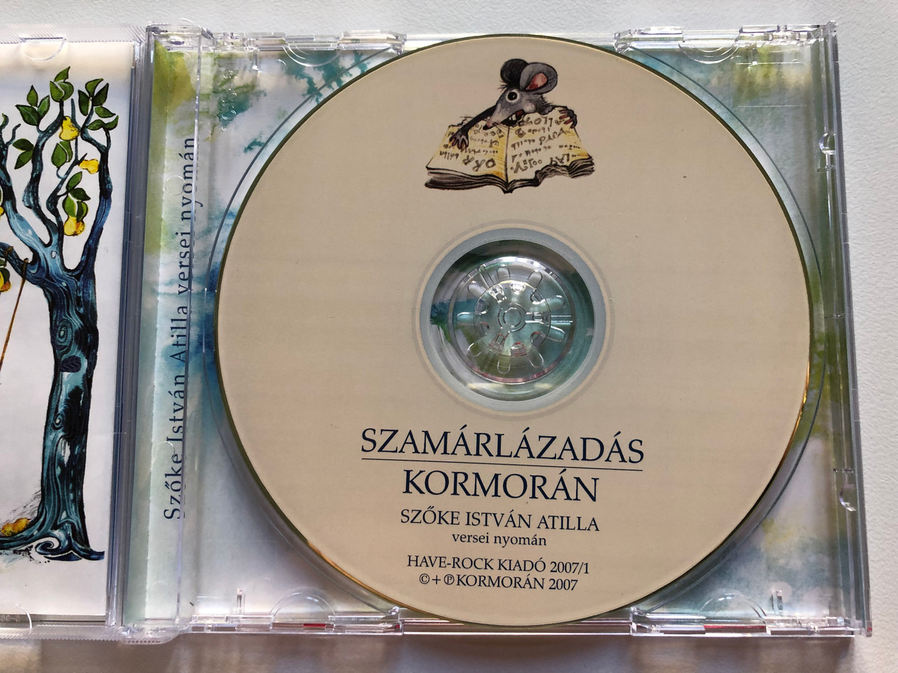 https://cdn10.bigcommerce.com/s-62bdpkt7pb/products/0/images/208916/Kormorn_Szamrlzads_Szke_Istvn_Atilla_versei_nyoman_Have-Rock_Bt._Audio_CD_2007_5998272707213_3__94743.1643127856.1280.1280.JPG?c=2&_gl=1*1bzo57c*_ga*MjA2NTIxMjE2MC4xNTkwNTEyNTMy*_ga_WS2VZYPC6G*MTY0MzEyNTY1Mi4yNzIuMS4xNjQzMTI3ODEwLjYw