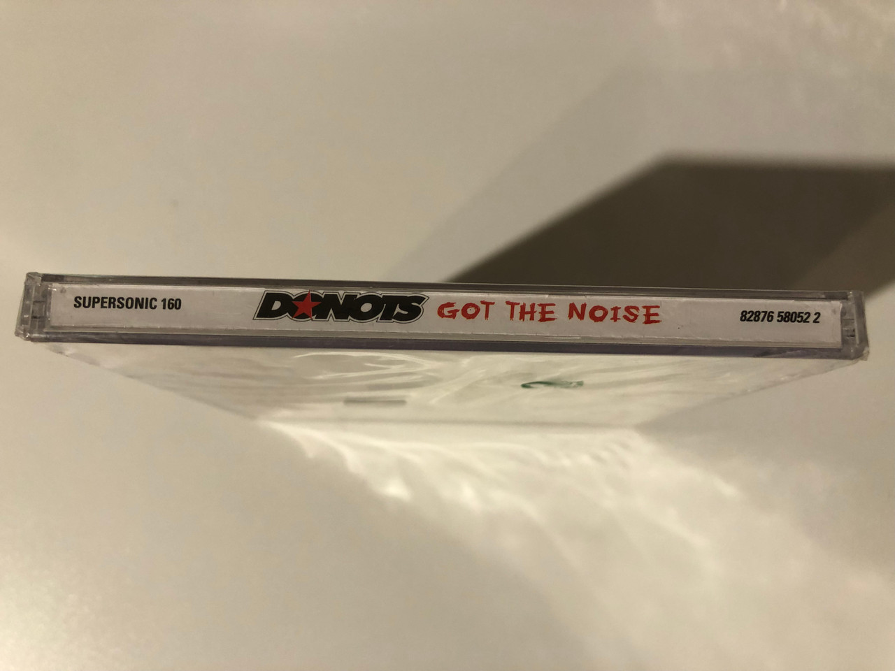 https://cdn10.bigcommerce.com/s-62bdpkt7pb/products/0/images/209209/Donots_Got_The_Noise_Supersonic_Records_Audio_CD_2004_Supersonic_160_3__01724.1643214678.1280.1280.JPG?c=2&_gl=1*1b55i6a*_ga*MjA2NTIxMjE2MC4xNTkwNTEyNTMy*_ga_WS2VZYPC6G*MTY0MzIwOTQ0MC4yNzMuMS4xNjQzMjE0NTY2LjI3