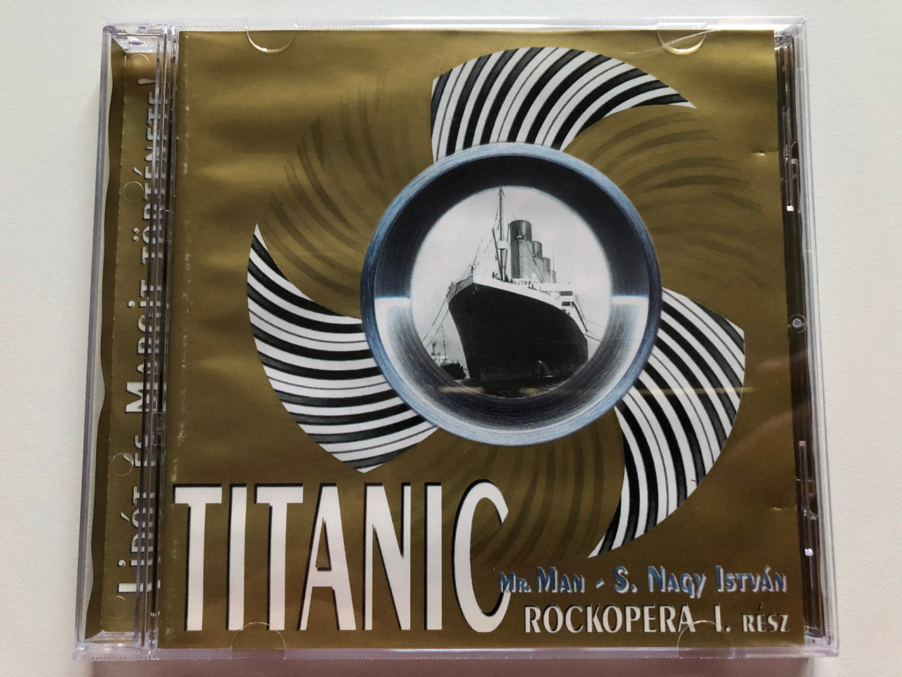 https://cdn10.bigcommerce.com/s-62bdpkt7pb/products/0/images/209858/Titanic_-_Mr._Man_S._Nagy_Istvn_-_Rockopera_-_I._Rsz_Lipt_s_Margit_Trtnete_Audio_CD_1999_G0017_1__10969.1643383471.1280.1280.JPG?c=2&_gl=1*bxcqma*_ga*MjA2NTIxMjE2MC4xNTkwNTEyNTMy*_ga_WS2VZYPC6G*MTY0MzM4MjMyNi4yNzkuMS4xNjQzMzgzMDA2LjYw