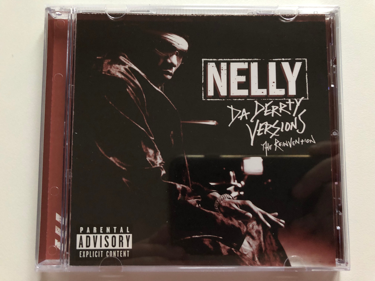 https://cdn10.bigcommerce.com/s-62bdpkt7pb/products/0/images/210054/Nelly_Da_Derrty_Versions_The_Reinvention_Universal_Records_Audio_CD_2003_0602498613115_1__74825.1643394017.1280.1280.JPG?c=2&_gl=1*1do03kt*_ga*MjA2NTIxMjE2MC4xNTkwNTEyNTMy*_ga_WS2VZYPC6G*MTY0MzM4MjMyNi4yNzkuMS4xNjQzMzkzMzM1LjE0