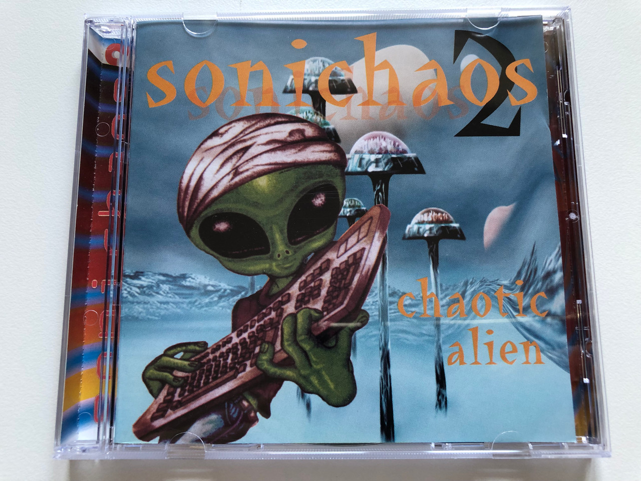 https://cdn10.bigcommerce.com/s-62bdpkt7pb/products/0/images/210937/Sonichaos_2_-_Chaotic_Alien_Planet_Music_Audio_CD_1999_07290005294358_1__42286.1643783453.1280.1280.JPG?c=2&_gl=1*19j6gyq*_ga*MjA2NTIxMjE2MC4xNTkwNTEyNTMy*_ga_WS2VZYPC6G*MTY0Mzc4MTAzOS4yODIuMS4xNjQzNzgzMzI2LjM.