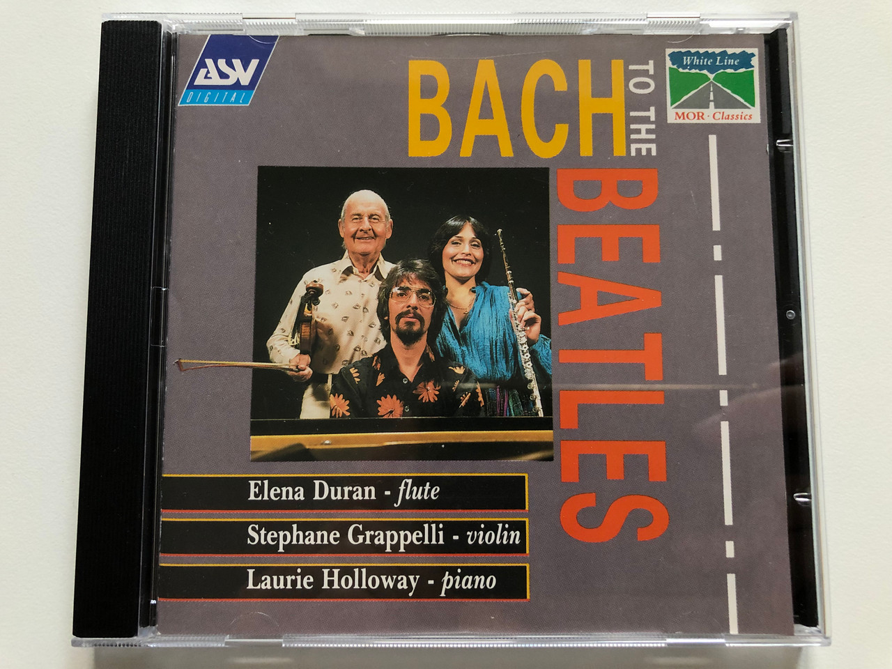 https://cdn10.bigcommerce.com/s-62bdpkt7pb/products/0/images/213101/Bach_To_The_Beatles_-_Elena_Duran_flute_Stphane_Grappelli_violin_Laurie_Holloway_piano_ASV_Digital_Audio_CD_1991_Stereo_CD_WHL_2056_1__43155.1644829883.1280.1280.JPG?c=2&_gl=1*1gone3*_ga*MjA2NTIxMjE2MC4xNTkwNTEyNTMy*_ga_WS2VZYPC6G*MTY0NDgxNTg1OC4yODUuMS4xNjQ0ODI5NjM5LjE0