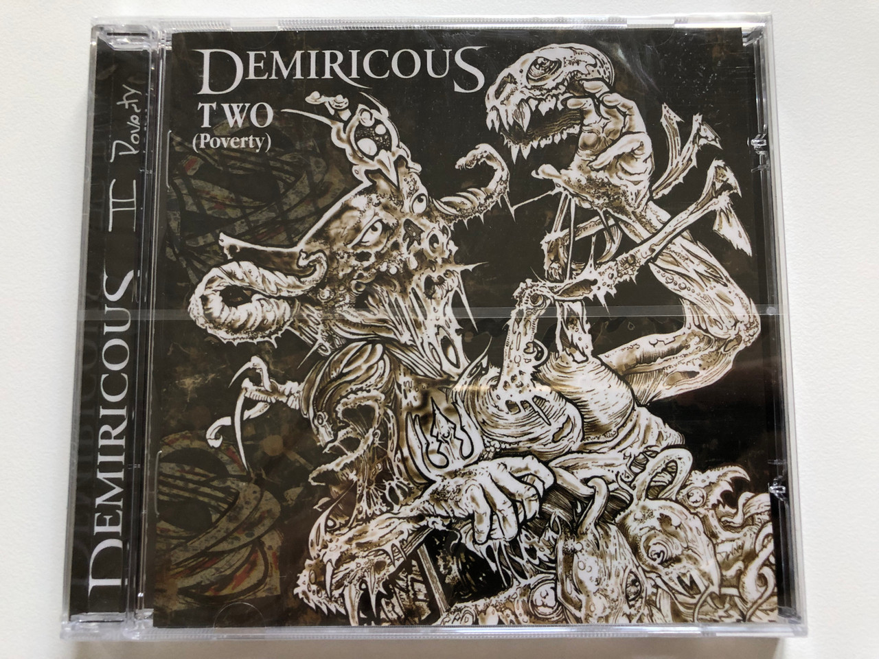https://cdn10.bigcommerce.com/s-62bdpkt7pb/products/0/images/213374/Demiricous_Two_Poverty_Metal_Blade_Records_Audio_CD_2007_3984-14626-2_1__78564.1645023760.1280.1280.JPG?c=2&_gl=1*1x5oo31*_ga*MjA2NTIxMjE2MC4xNTkwNTEyNTMy*_ga_WS2VZYPC6G*MTY0NTAxODQ4NS4yOTEuMS4xNjQ1MDIzNTgxLjU2