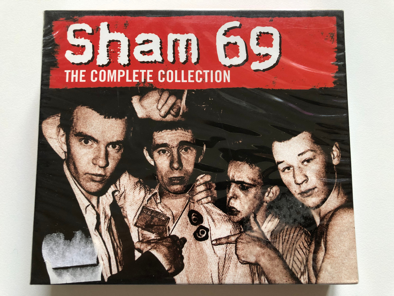https://cdn10.bigcommerce.com/s-62bdpkt7pb/products/0/images/213400/Sham_69_The_Complete_Collection_Sanctuary_Midline_3x_Audio_CD_2004_SMETD021_1__98127.1645075099.1280.1280.JPG?c=2&_gl=1*4t2nm6*_ga*MjA2NTIxMjE2MC4xNTkwNTEyNTMy*_ga_WS2VZYPC6G*MTY0NTA3MzEwMy4yOTIuMS4xNjQ1MDc1MDAzLjIy