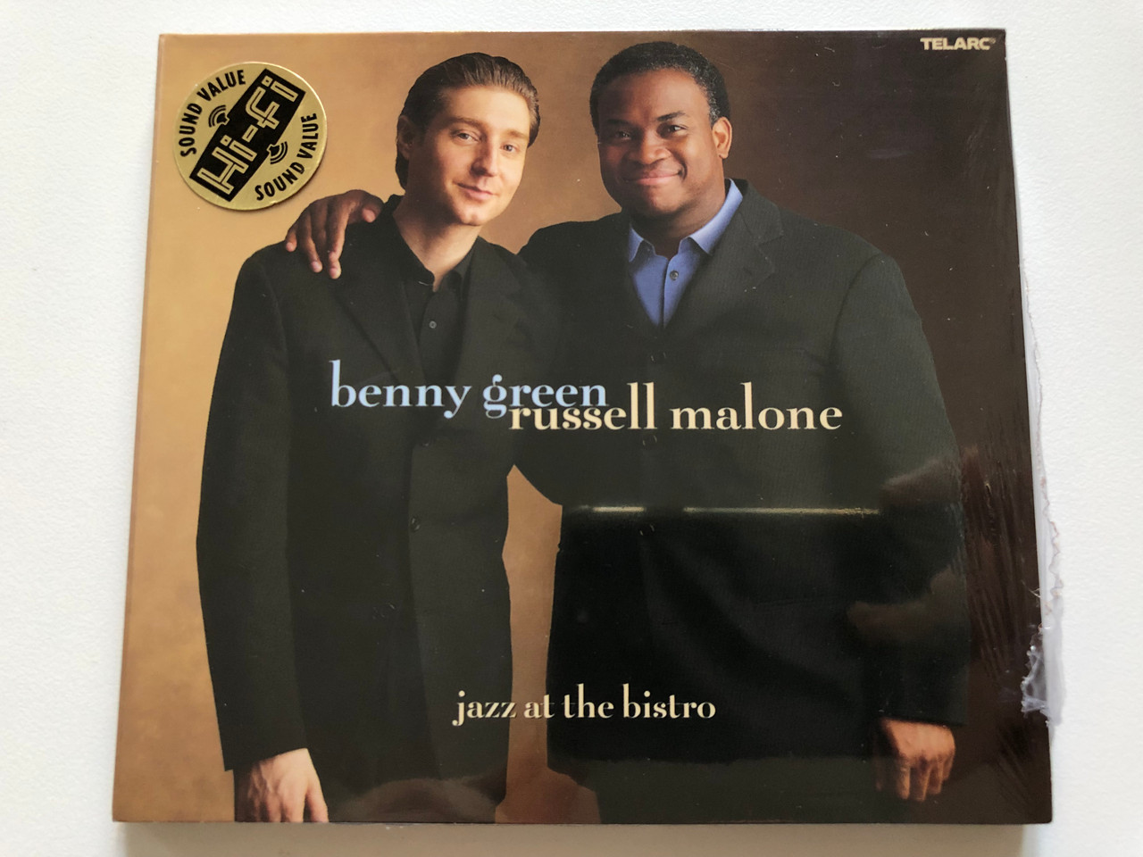https://cdn10.bigcommerce.com/s-62bdpkt7pb/products/0/images/213479/Benny_Green_Russell_Malone_Jazz_At_The_Bistro_Telarc_Audio_CD_2003_CD-83560_1__46694.1645094483.1280.1280.JPG?c=2&_gl=1*ui9ulq*_ga*MjA2NTIxMjE2MC4xNTkwNTEyNTMy*_ga_WS2VZYPC6G*MTY0NTA5MTM2Ni4yOTMuMS4xNjQ1MDk0NDk3LjYw