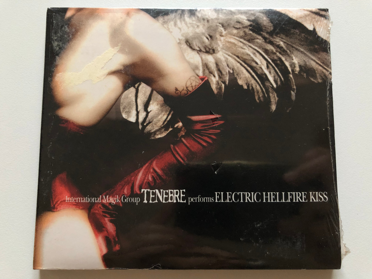 https://cdn10.bigcommerce.com/s-62bdpkt7pb/products/0/images/214103/International_Magik_Group_Tenebre_performs_Electric_Hellfire_Kiss_Regain_Records_Audio_CD_RR0209-015_1__70921.1645620418.1280.1280.JPG?c=2&_gl=1*xy7d0i*_ga*MjA2NTIxMjE2MC4xNTkwNTEyNTMy*_ga_WS2VZYPC6G*MTY0NTYxOTU2OS4yOTkuMS4xNjQ1NjIwMjUxLjM2