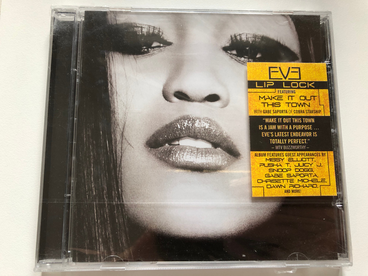 https://cdn10.bigcommerce.com/s-62bdpkt7pb/products/0/images/214423/Eve_Lip_Lock_Featuring_Make_It_Out_This_Town_With_Gabe_Saporta_of_Cobra_Starship_Album_Features_Guest_Appearances_By_Missy_Elliot_Pusha_T_Juicy_J_Snoop_Dogg_Gabe_Saporta_From_The_R_1__77042.1646021665.1280.1280.JPG?c=2&_gl=1*1x6gg9x*_ga*MjA2NTIxMjE2MC4xNTkwNTEyNTMy*_ga_WS2VZYPC6G*MTY0NjAxOTM2NS4zMDQuMS4xNjQ2MDIxMDc4LjM5