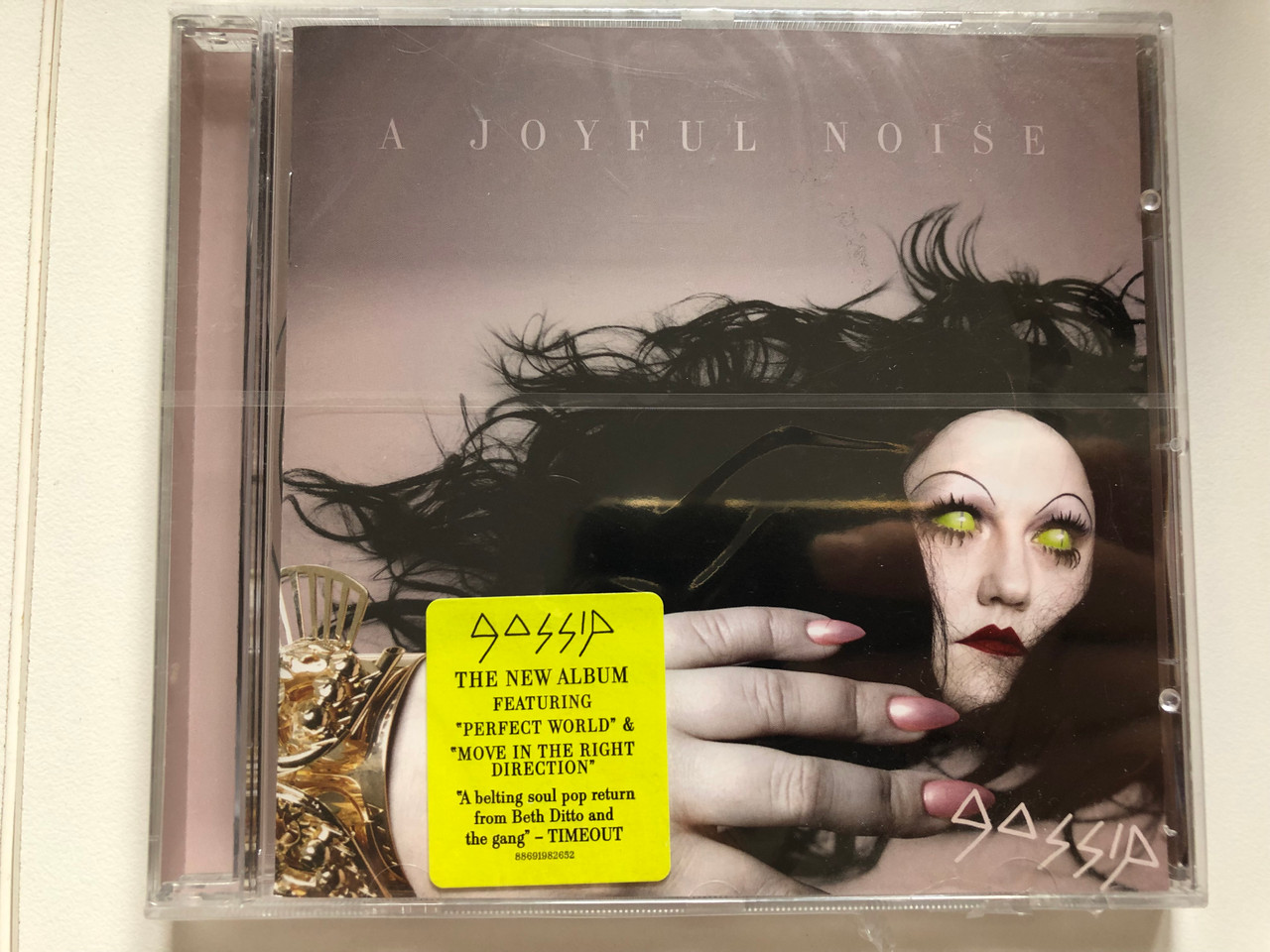 https://cdn10.bigcommerce.com/s-62bdpkt7pb/products/0/images/214428/Gossip_A_Joyful_Noise_The_New_Album_Featuring_Perfect_World_Move_In_The_Right_Direction_Columbia_Audio_CD_2012_88691982652_1__66801.1646023522.1280.1280.JPG?c=2&_gl=1*xp1bxa*_ga*MjA2NTIxMjE2MC4xNTkwNTEyNTMy*_ga_WS2VZYPC6G*MTY0NjAxOTM2NS4zMDQuMS4xNjQ2MDIyNzk3LjI1