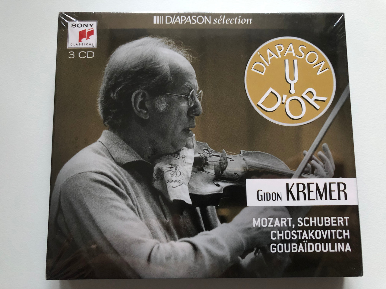 https://cdn10.bigcommerce.com/s-62bdpkt7pb/products/0/images/215379/Gidon_Kremer_-_Mozart_Schubert_Chostakovitch_Goubadoulina_Diapason_Slection_Sony_Classical_3x_Audio_CD_2015_88875111492_1__32923.1646648120.1280.1280.JPG?c=2&_gl=1*pvr2qa*_ga*MjA2NTIxMjE2MC4xNTkwNTEyNTMy*_ga_WS2VZYPC6G*MTY0NjYzNjE3MC4zMTIuMS4xNjQ2NjQ3OTIwLjQx