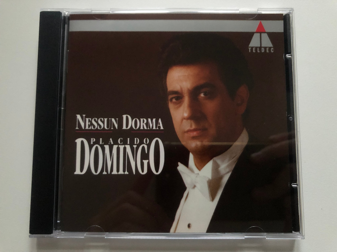 https://cdn10.bigcommerce.com/s-62bdpkt7pb/products/0/images/216388/Nessun_Dorma_-_Placido_Domingo_Teldec_Audio_CD_1991_9031-73741-2_1__63001.1647272622.1280.1280.JPG?c=2&_gl=1*1nrhvmz*_ga*MjA2NTIxMjE2MC4xNTkwNTEyNTMy*_ga_WS2VZYPC6G*MTY0NzI3MDg0Ny4zMTkuMS4xNjQ3MjcyNDg5LjQ0