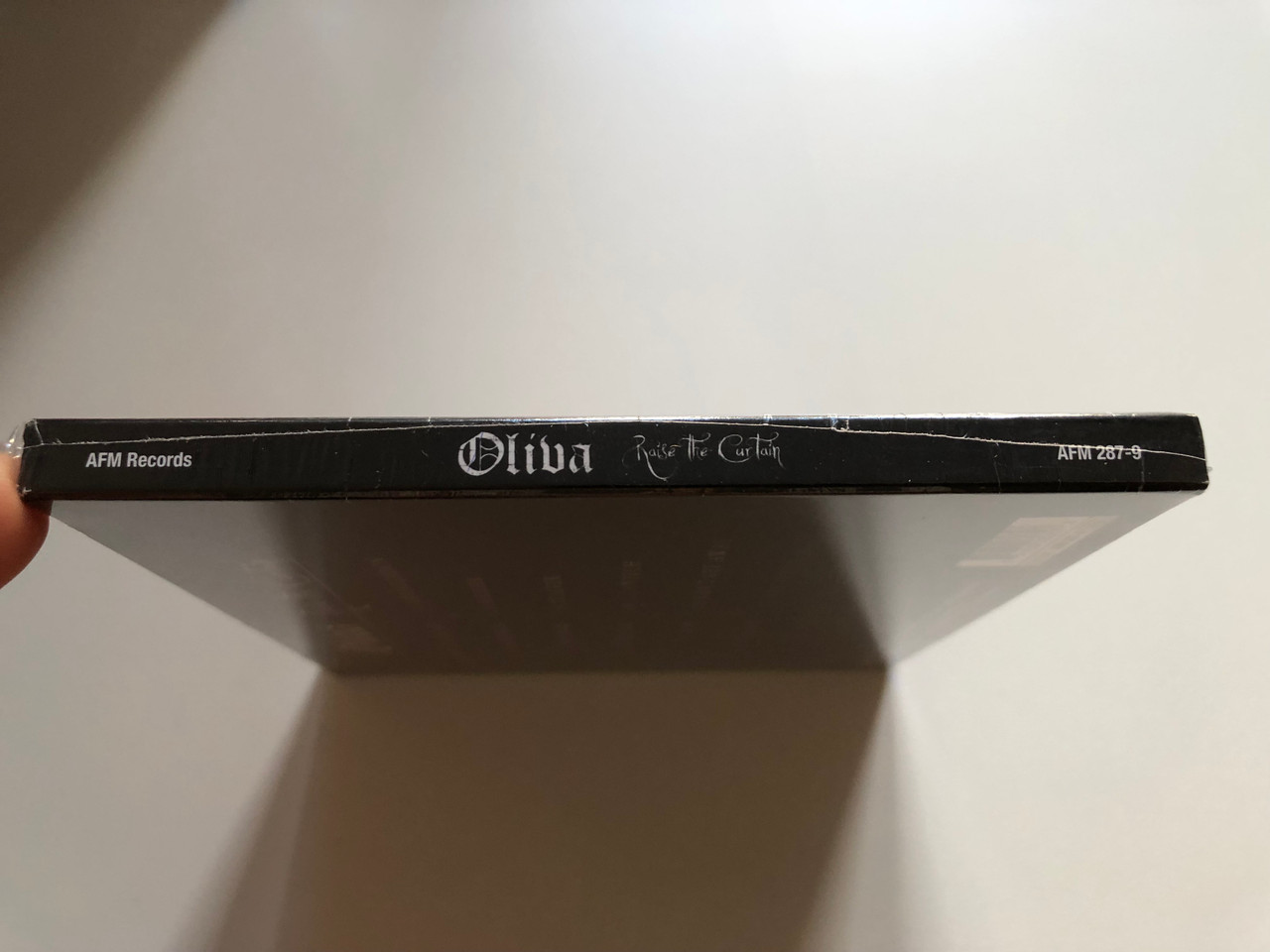 https://cdn10.bigcommerce.com/s-62bdpkt7pb/products/0/images/218442/Oliva_Raise_The_Curtain_Jon_Oliva_the_mastermind_of_Savatage_presents_his_first_Solo_Album_ever_First_Edition_Includes_One_Bonus_Track_AFM_Records_Audio_CD_2013_AFM_287-9_3__00057.1648222288.1280.1280.JPG?c=2&_gl=1*bu7ayv*_ga*MjA2NTIxMjE2MC4xNTkwNTEyNTMy*_ga_WS2VZYPC6G*MTY0ODIxMDI4Ny4zMzMuMS4xNjQ4MjIyNDA1LjYw