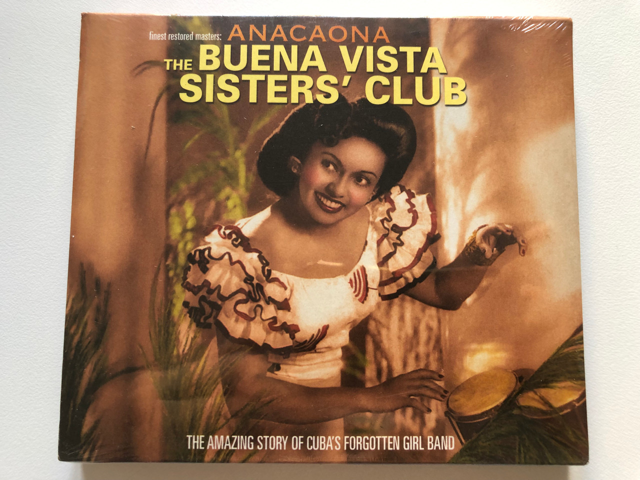https://cdn10.bigcommerce.com/s-62bdpkt7pb/products/0/images/220712/Anacaona_The_Buena_Vista_Sisters_Club_The_Amazing_Story_Of_Cubas_Forgotten_Girl_Band_Pati_Pami_Audio_CD_71030_1__97939.1649177545.1280.1280.JPG?c=2&_gl=1*pevild*_ga*MjA2NTIxMjE2MC4xNTkwNTEyNTMy*_ga_WS2VZYPC6G*MTY0OTE2ODI5OS4zNDMuMS4xNjQ5MTc3NTM1LjYw